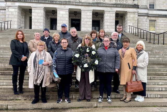 Dympna Kerr, the sister of Disappeared victim Columba McVeigh (holding wreath) joins families of the Disappeared victims of the Northern Ireland Troubles taking part in their annual All Souls Day silent walk at Stormont to remember the five victims whose remains are yet to be found. Picture date: Saturday November 2, 2024.