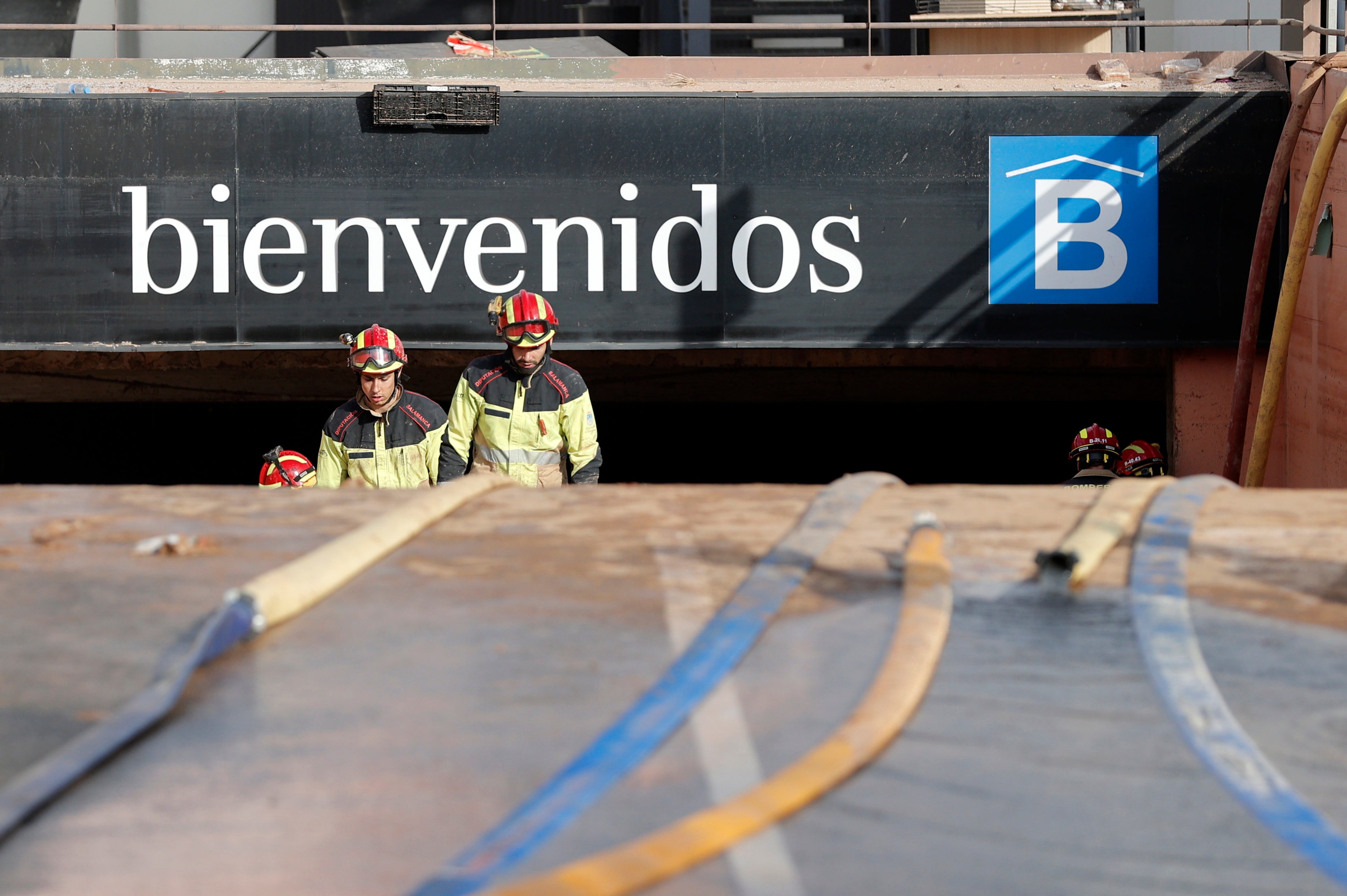 Firefighters at a flooded underground car park at Bonaire mall in Valencia – there are fears that large numbers of bodies remain trapped inside