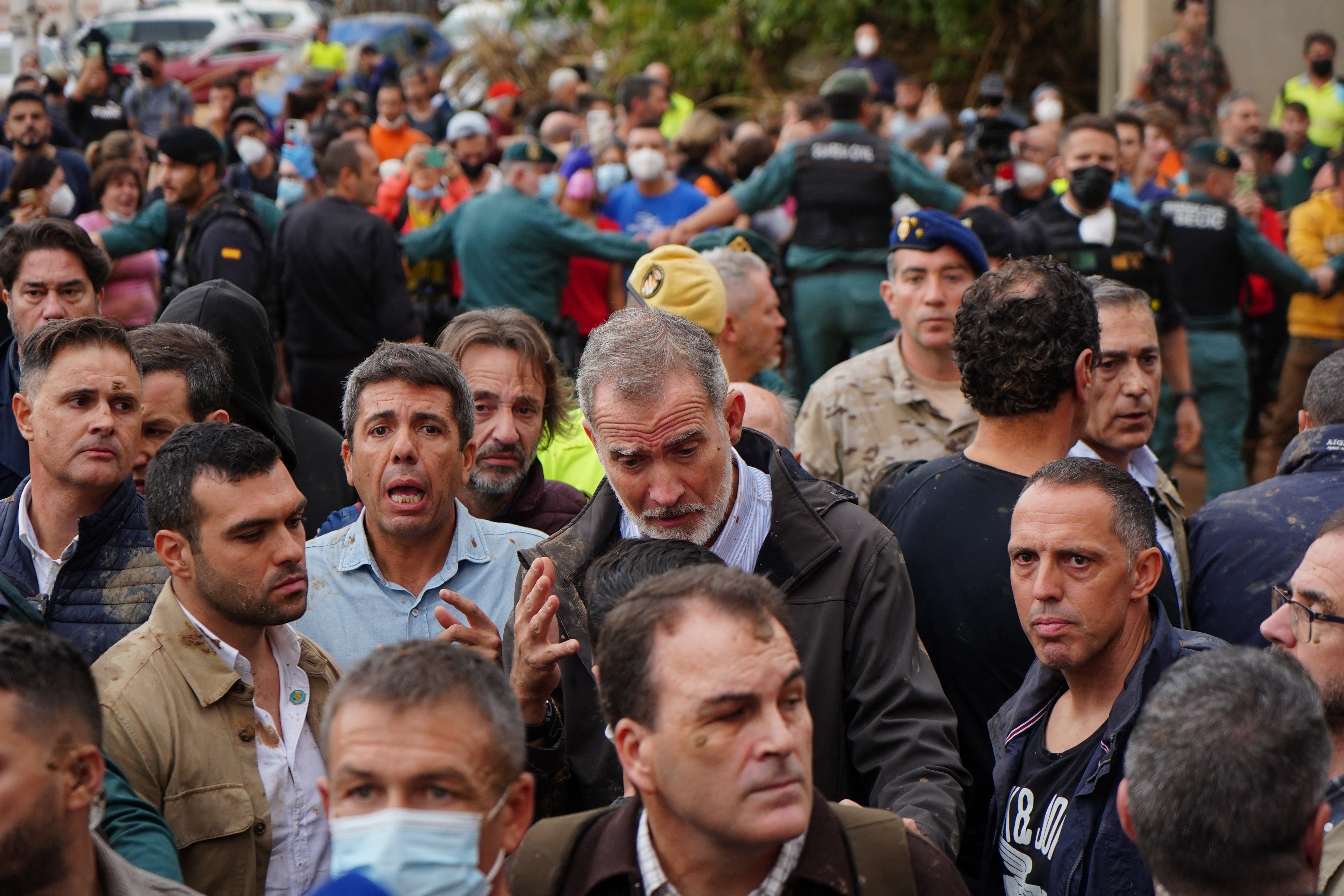 King Felipe VI of Spain (centre) is heckled by angry residents during his visit to Paiporta