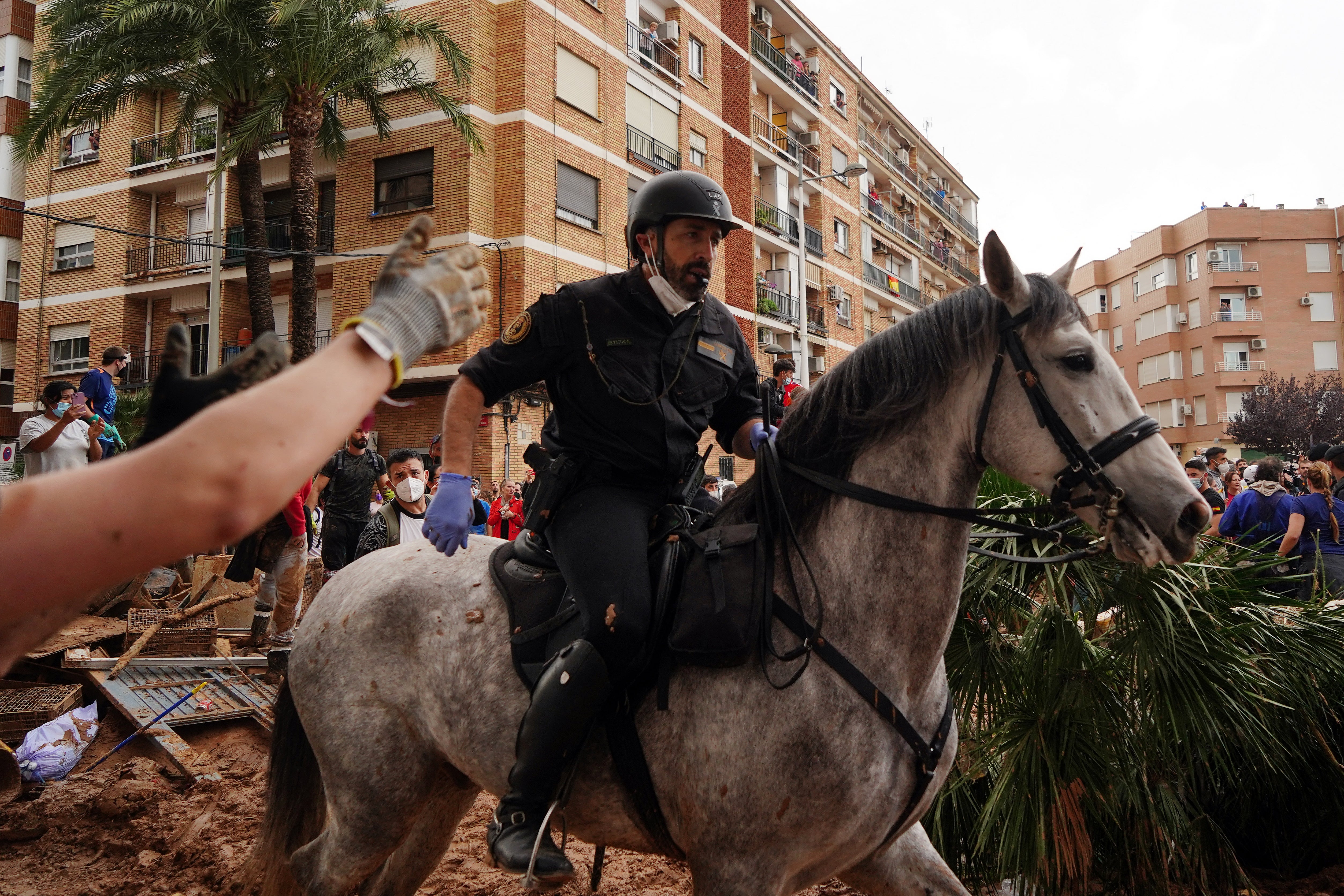 A police officer rides a horse as residents of Paiporta react to King Felipe VI of Spain's visit to this town