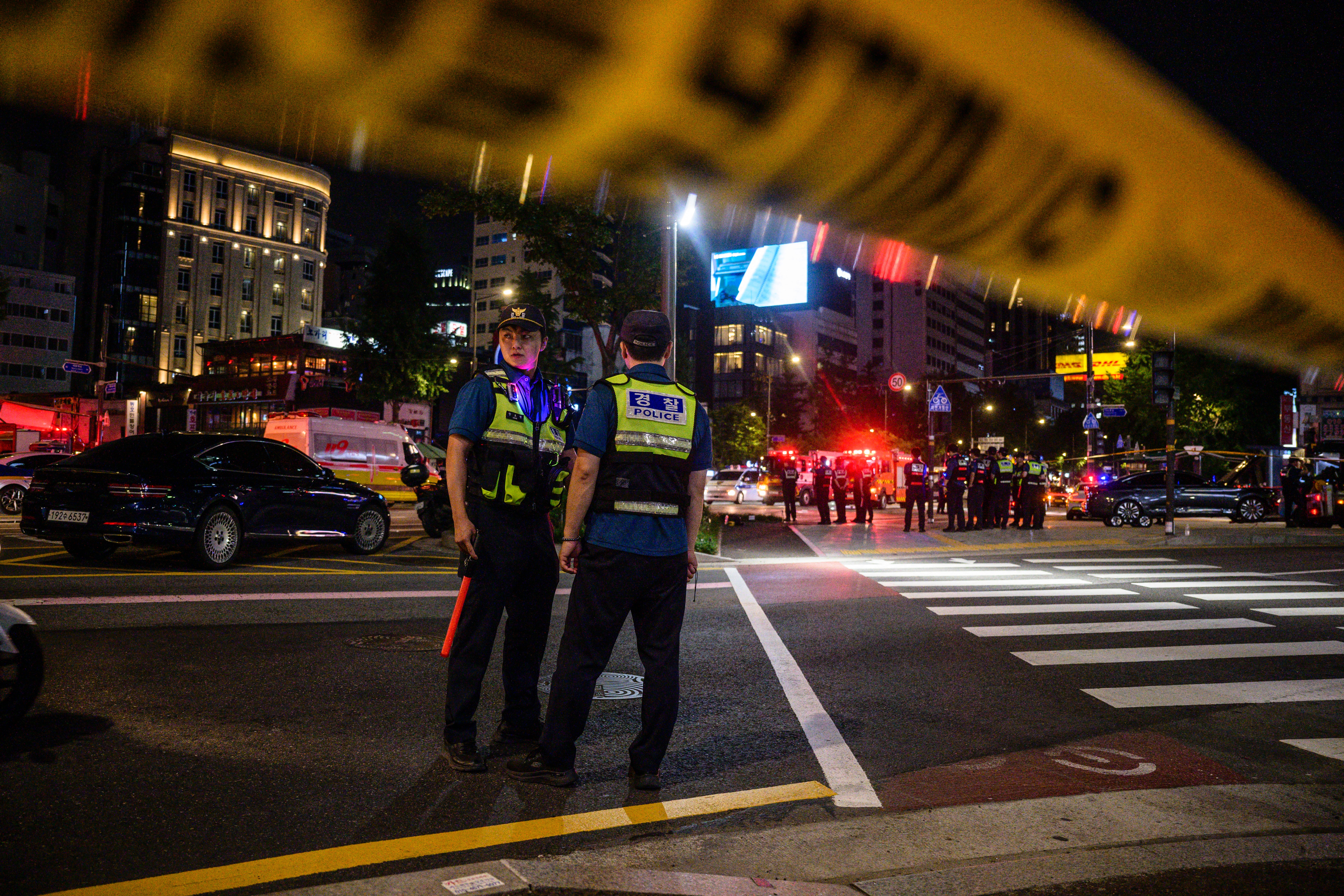 File: Police stand near the site of a car accident, which left at least nine people dead, in Seoul late on 1 July 2024