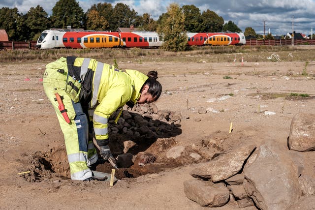 <p>Archaeologist Tamara Gomez Kobayashi works in the field with one of the graves</p>