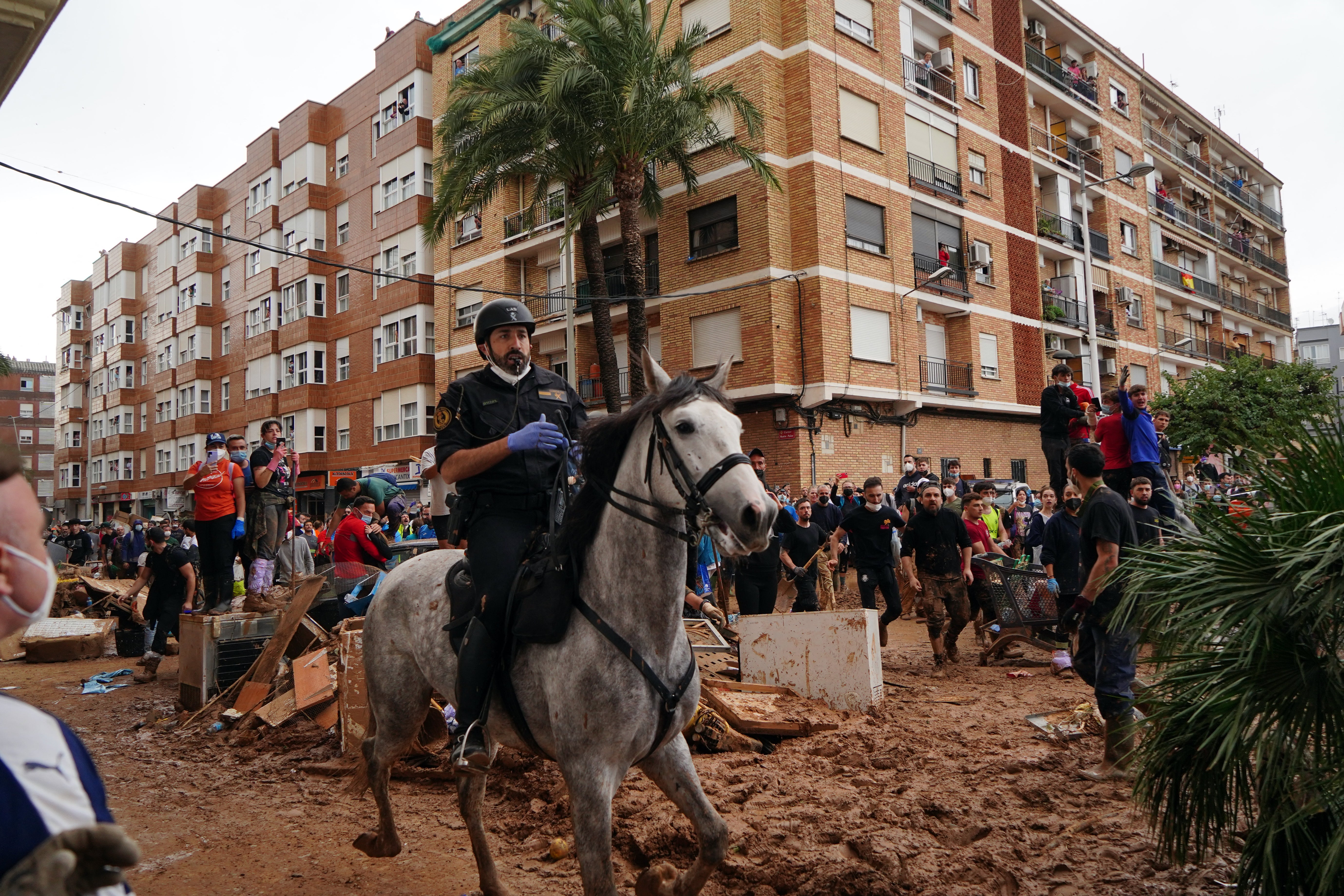 A civil guard rides a horse as residents of Paiporta protest and throw mud and objects during King Felipe VI of Spain's visit to this town, in the region of Valencia, eastern Spain