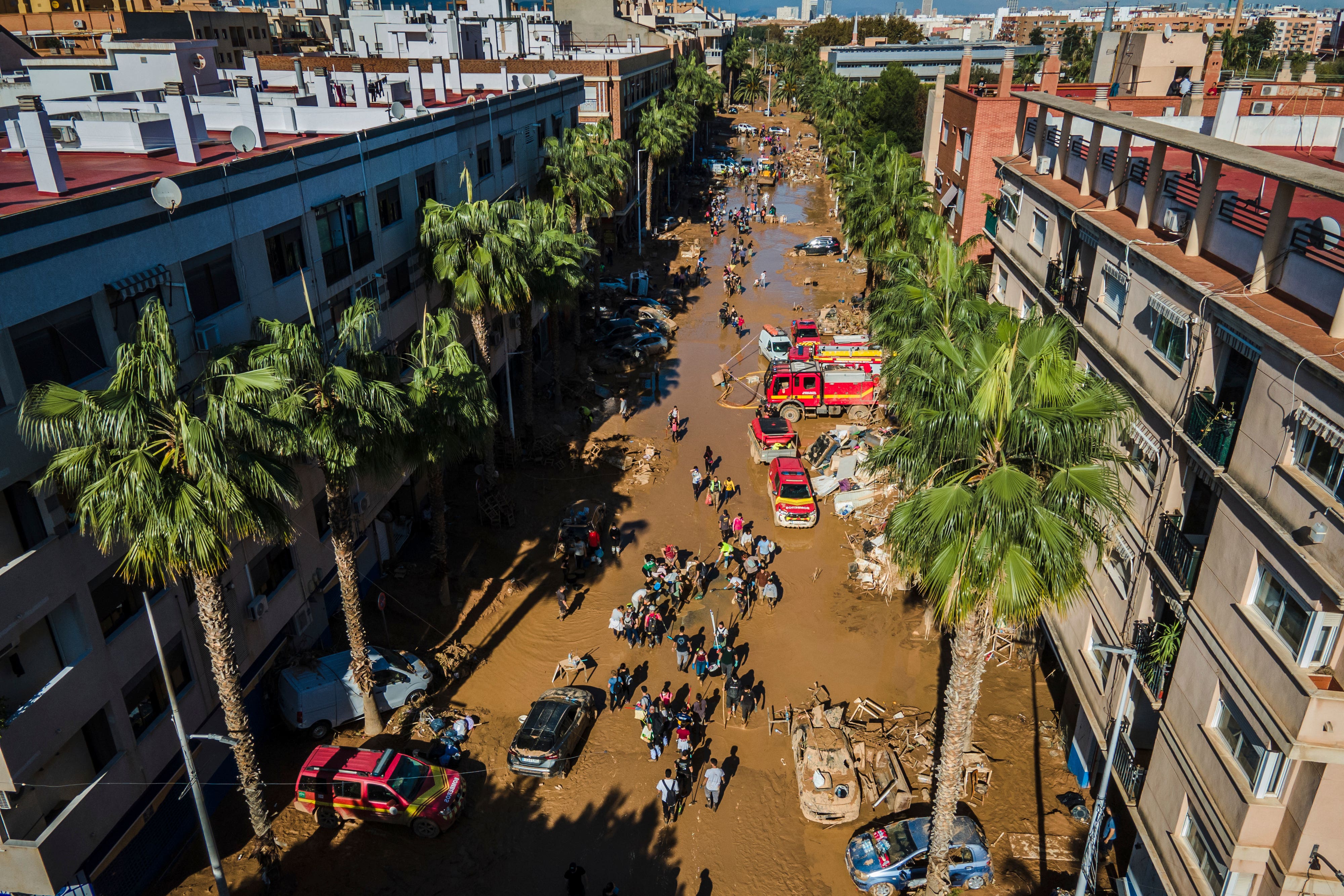 Volunteers and residents in Valencia clean the mud four days after flash floods (Angel Garcia/AP)