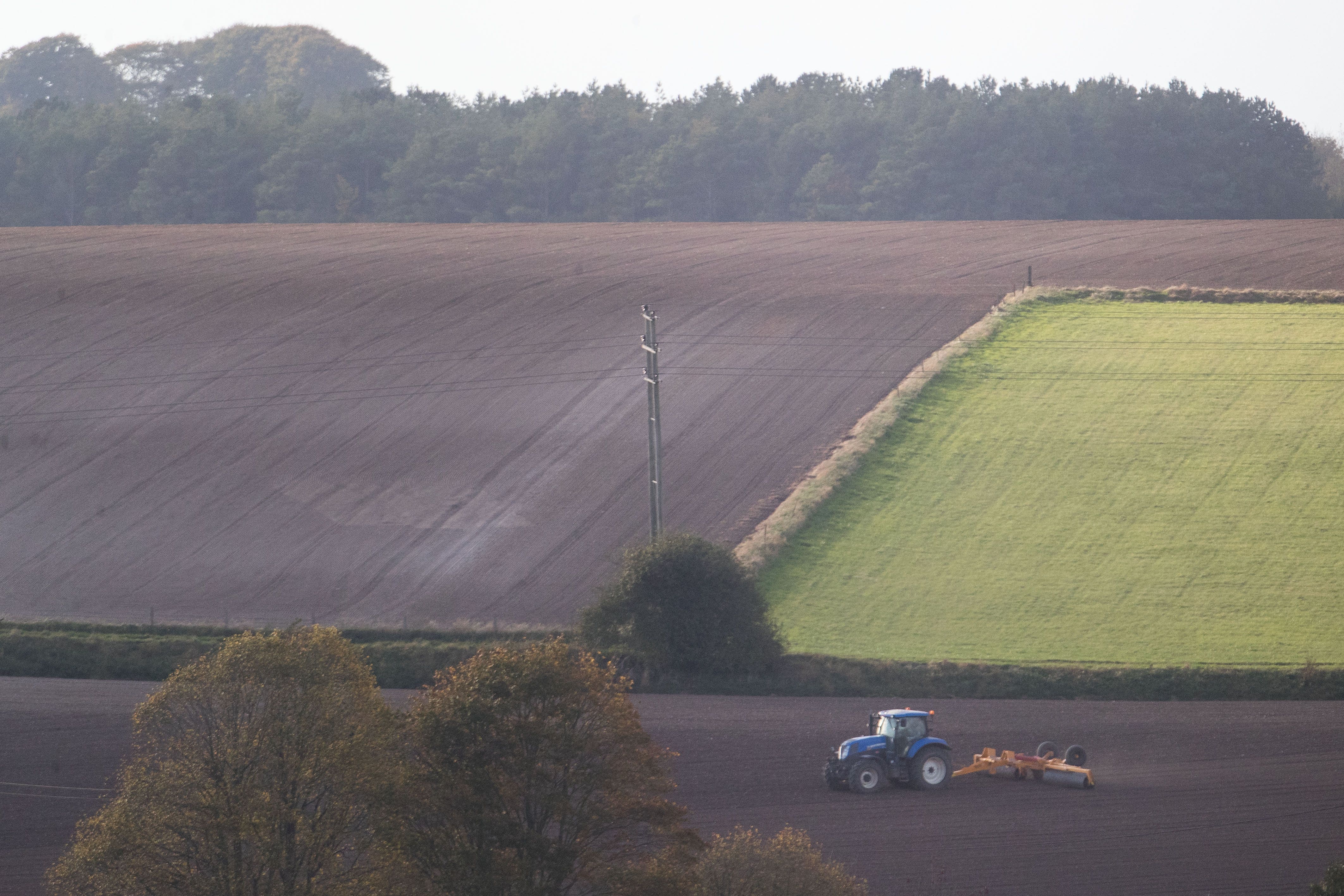 Tractors work on fields (Steve Parsons/PA)