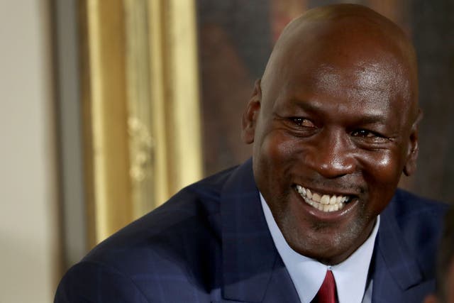 <p>Michael Jordan smiling before being awarded the Presidential Medal of Freedom by Barack Obama in 2016</p>