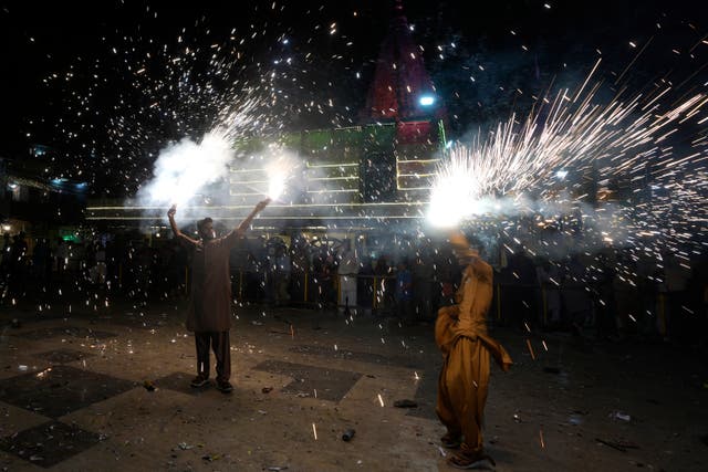 <p>Representative: People hold fireworks at a ceremony to celebrate Diwali</p>