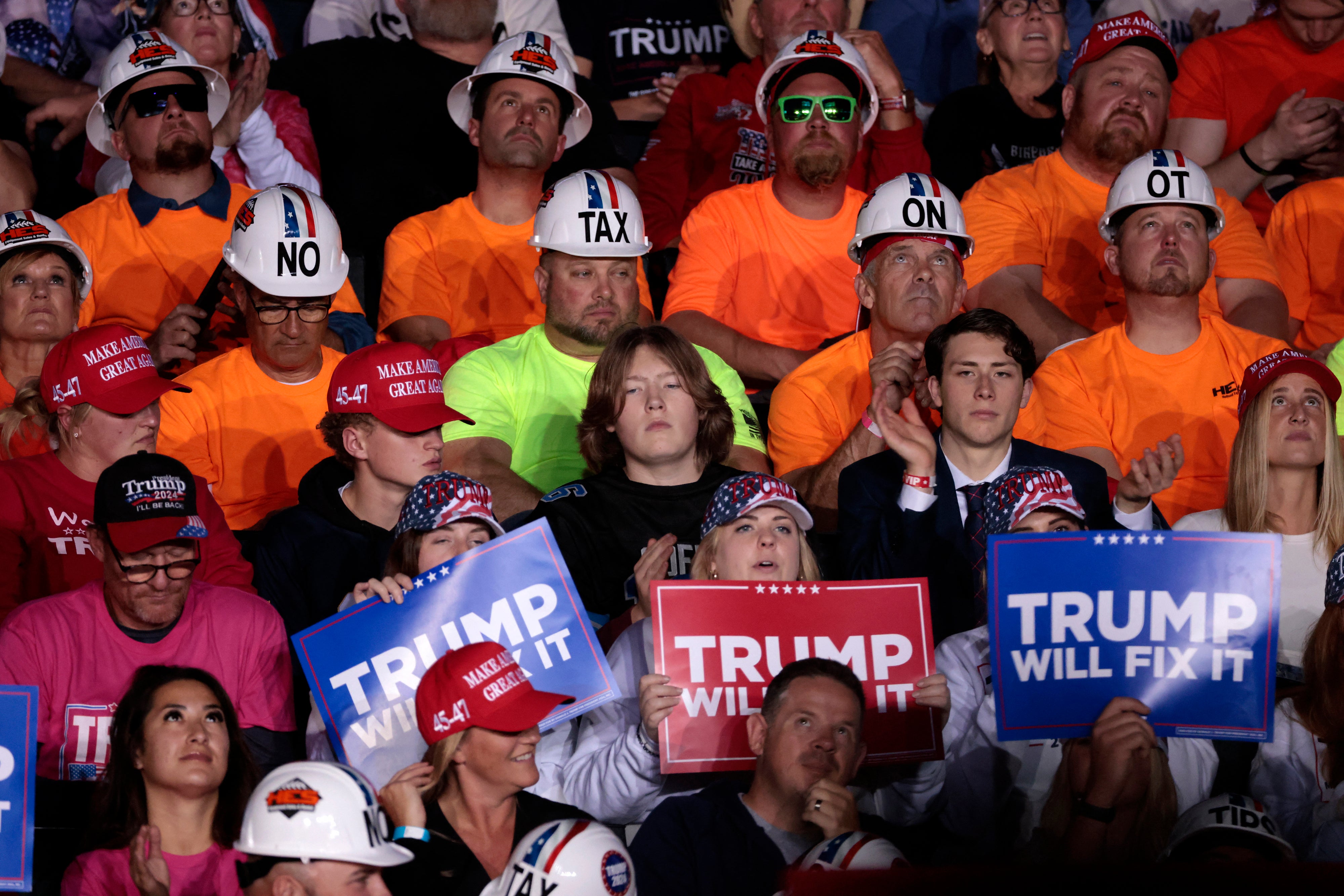 Supporters listen to speakers before former US President and Republican presidential candidate Donald Trump holds his final campaign rally before election day at Van Andel Arena in Grand Rapids, Michigan