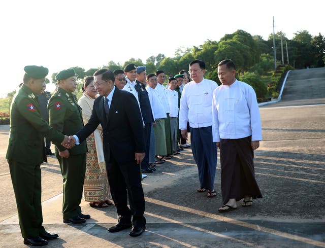 <p>Myanmar military leader Senior Gen Min Aung Hlaing, front right, shakes hands with a military officer </p>