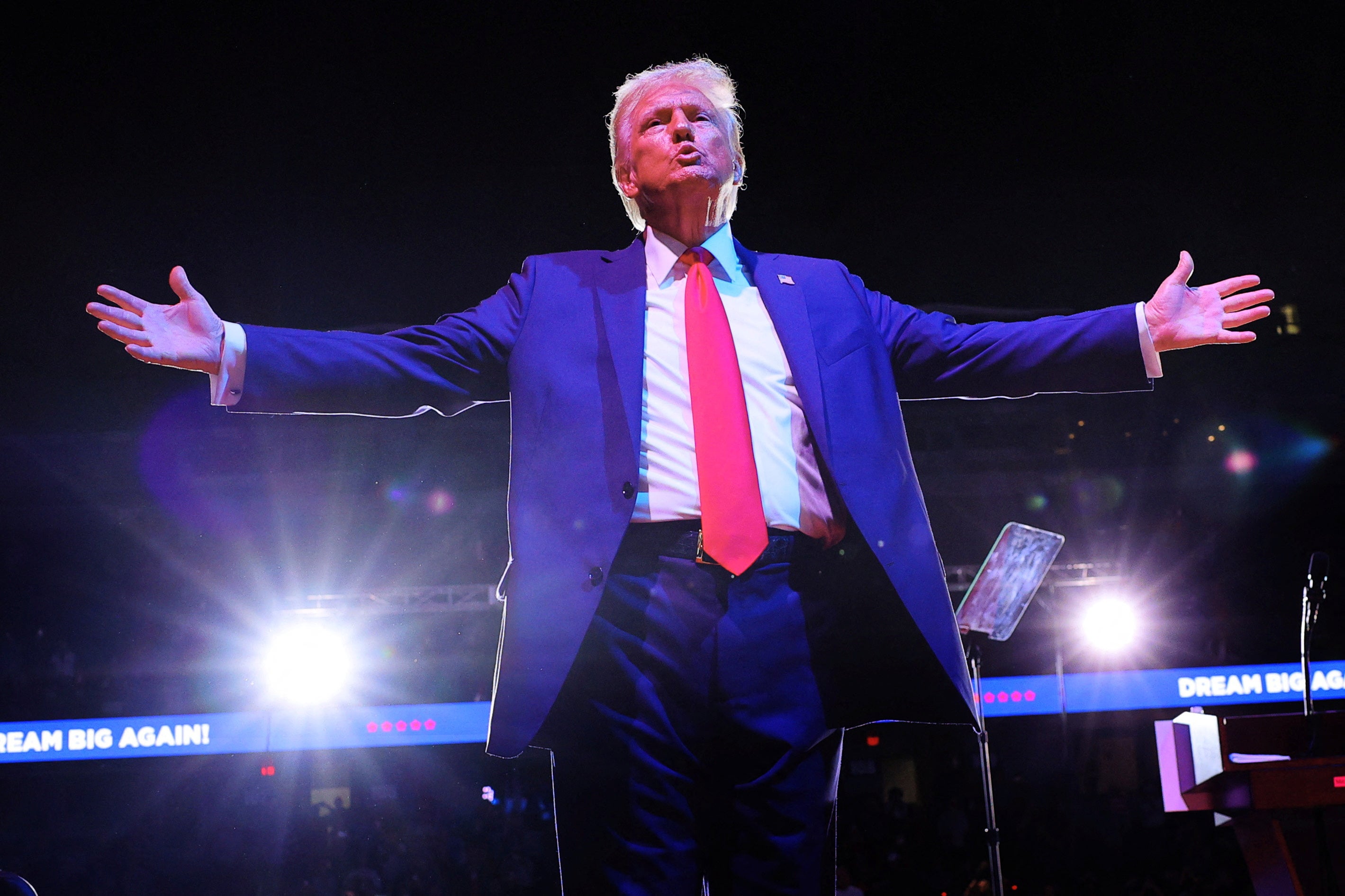 Trump gestures to the crowd at his last rally Van Andel Arena in Grand Rapids, Michigan in the early hours of Tuesday morning