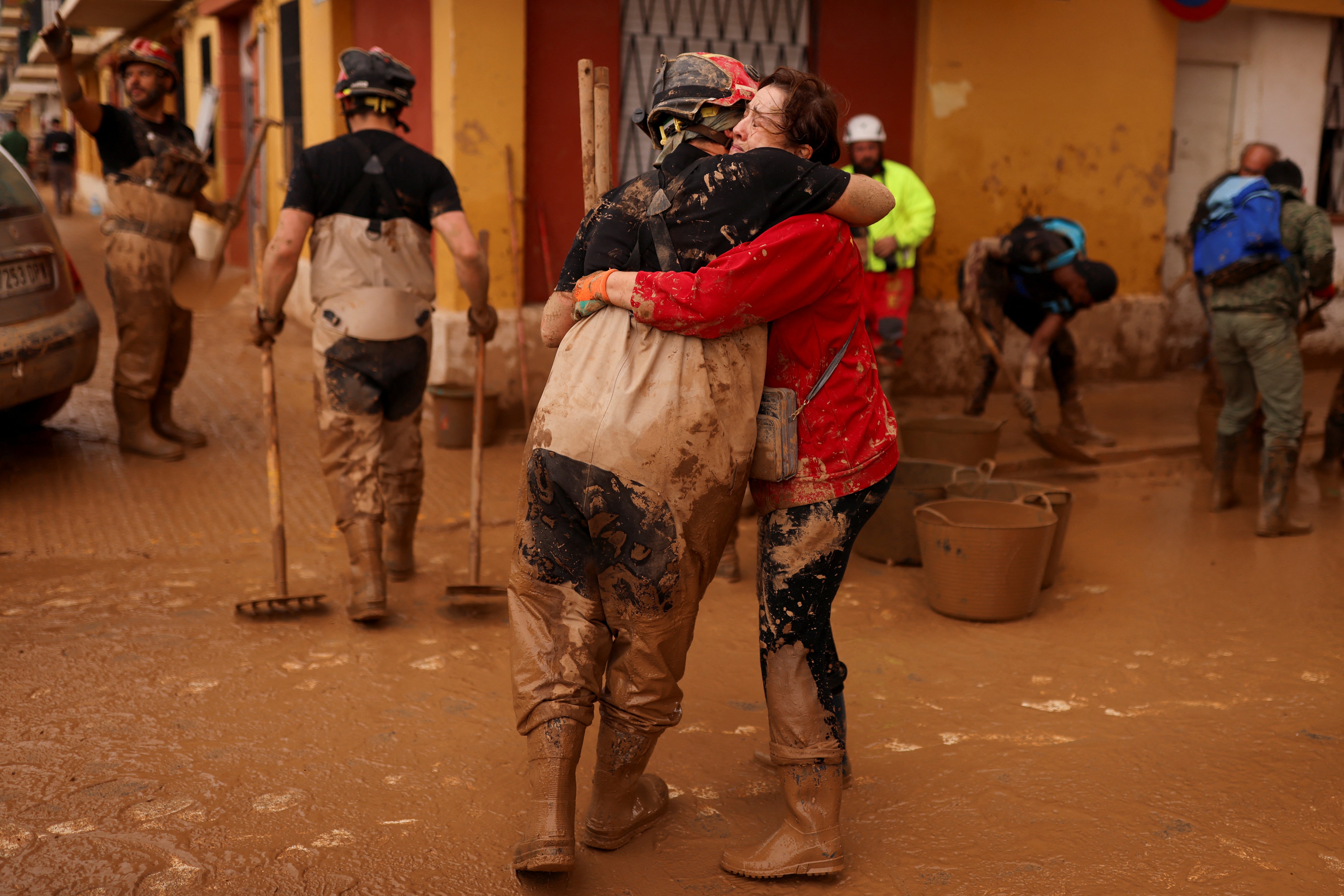 A member of Spain's Military Emergency Unit (UME) embraces with a local woman, in the aftermath of floods caused by heavy rains, in Sedavi, near Valencia, Spain