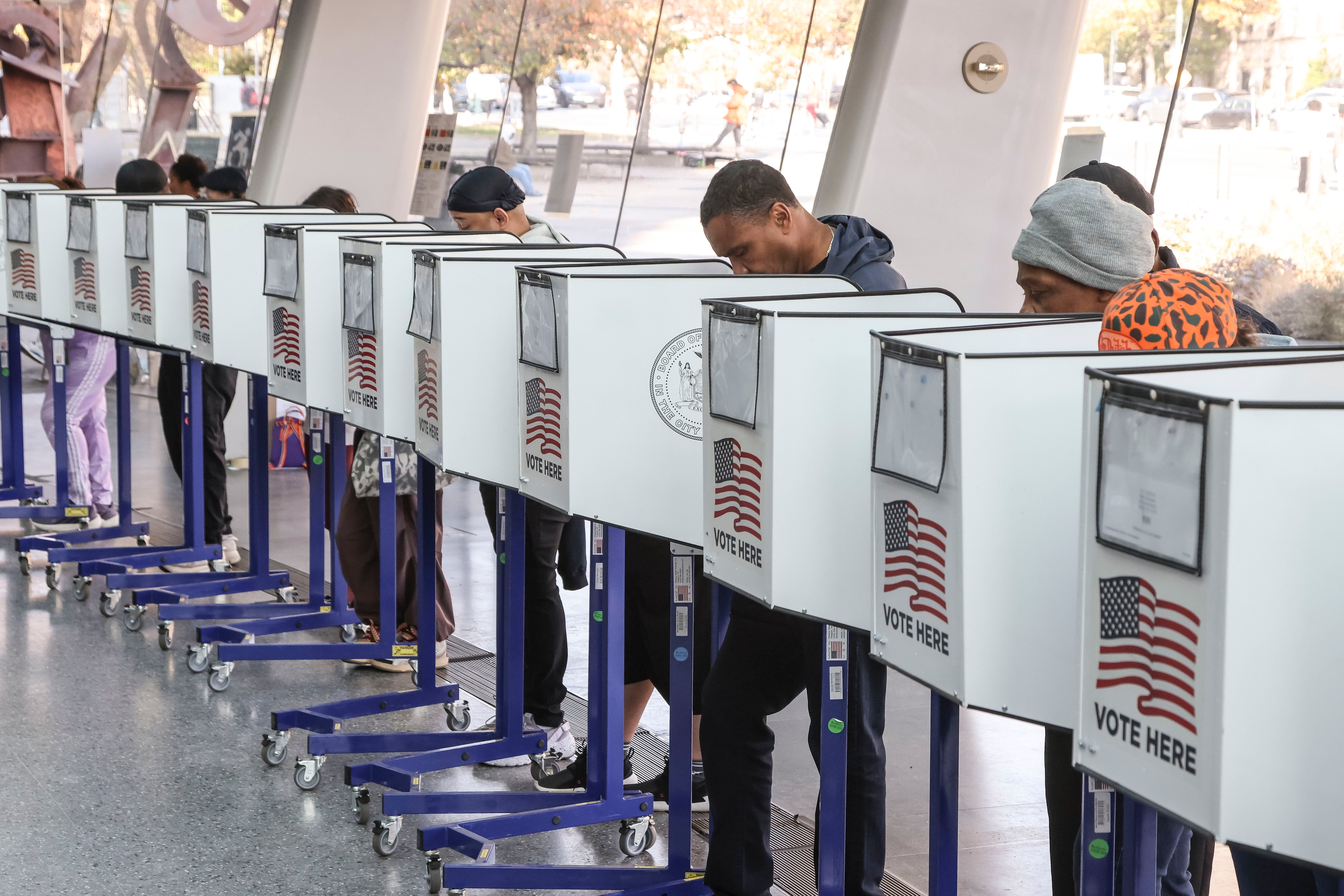 Voters cast ballots at a polling site in the lobby of the Brooklyn Museum on Election Day