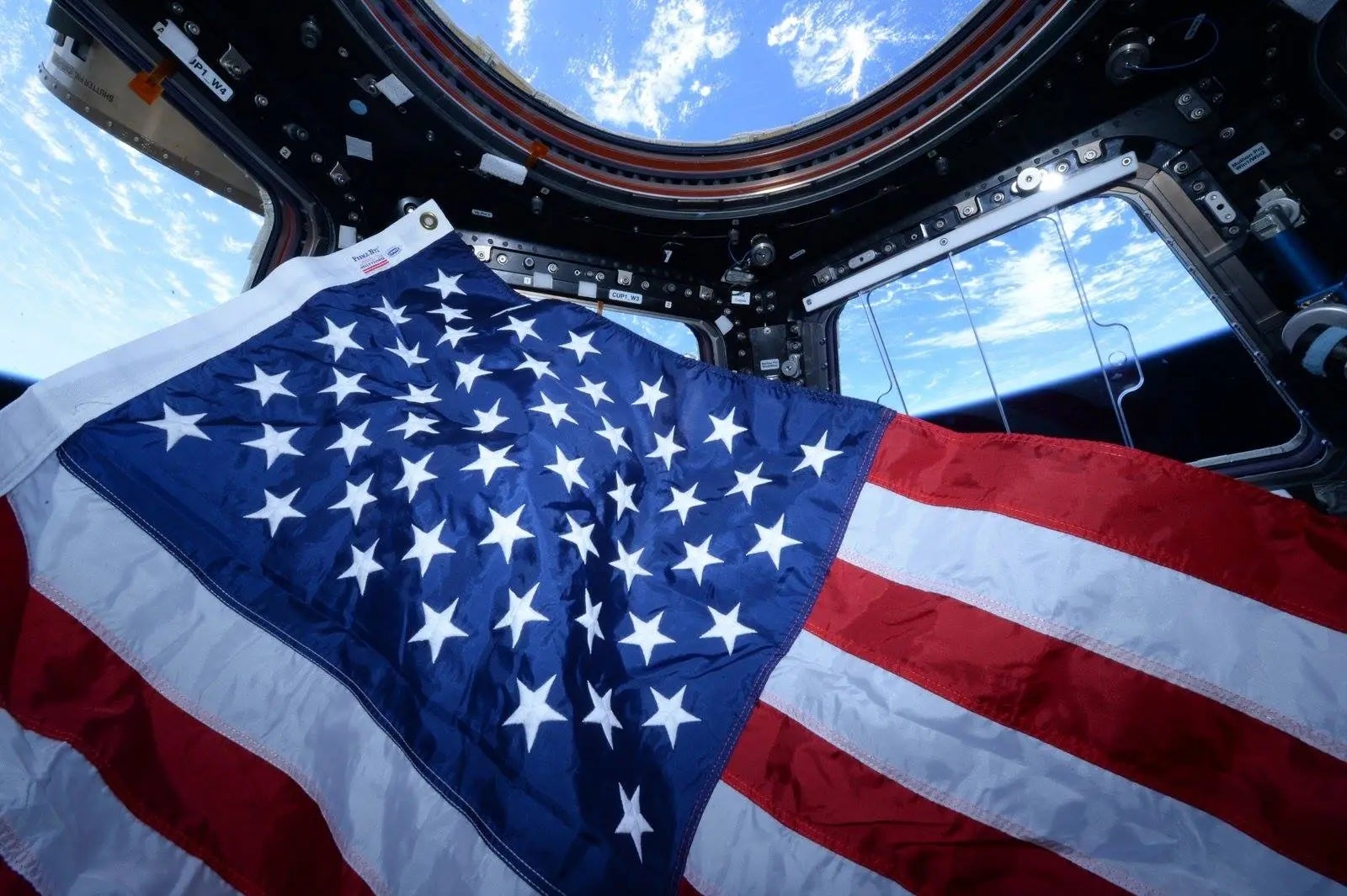 An American flag is seen inside the cupola of the International Space Station. NASA astronauts have been voting in US elections from space for nearly 30 years.