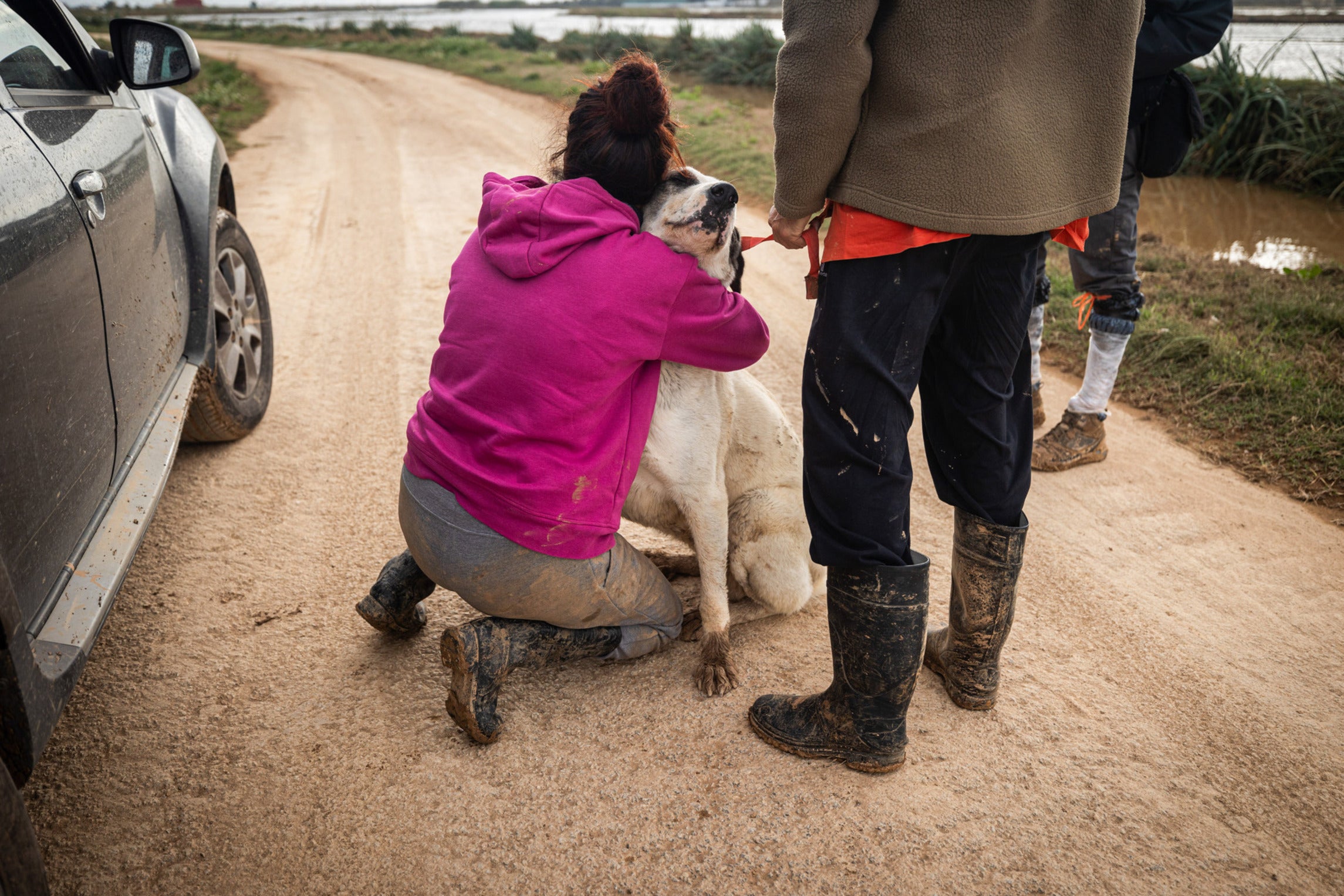 An owner is reunited with her dog following the flood