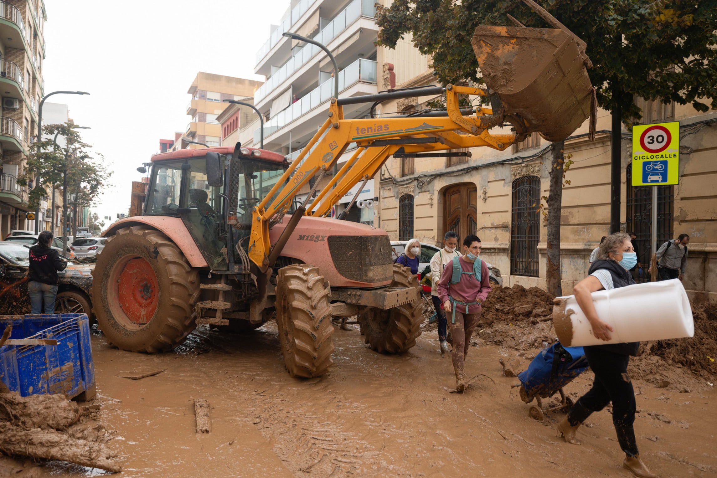 Valencian volunteer citizens are carrying out cleanup work on streets flooded and filled