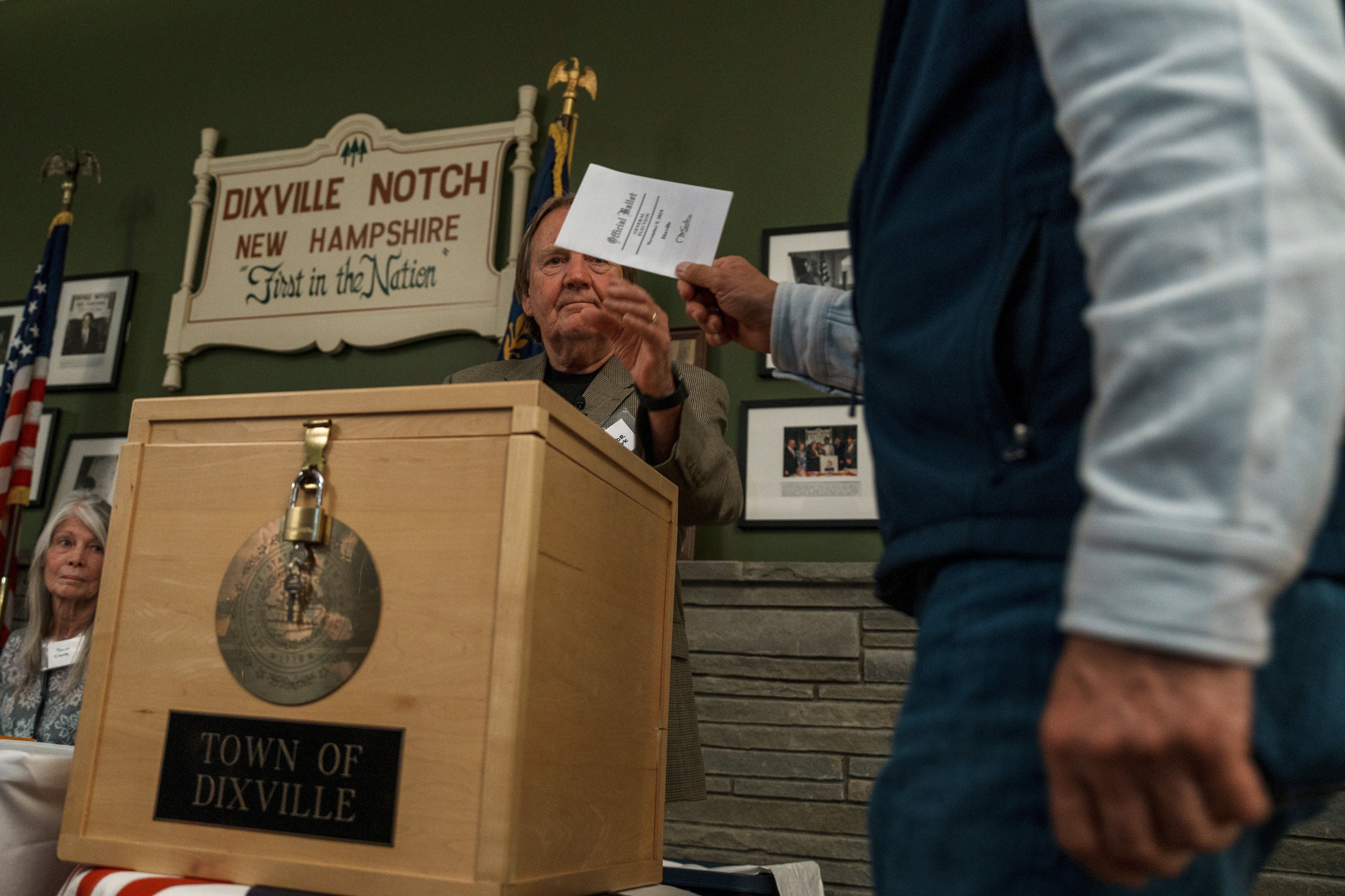 : Les Otten casts the first of six ballots after the polls open in Dixville Notch