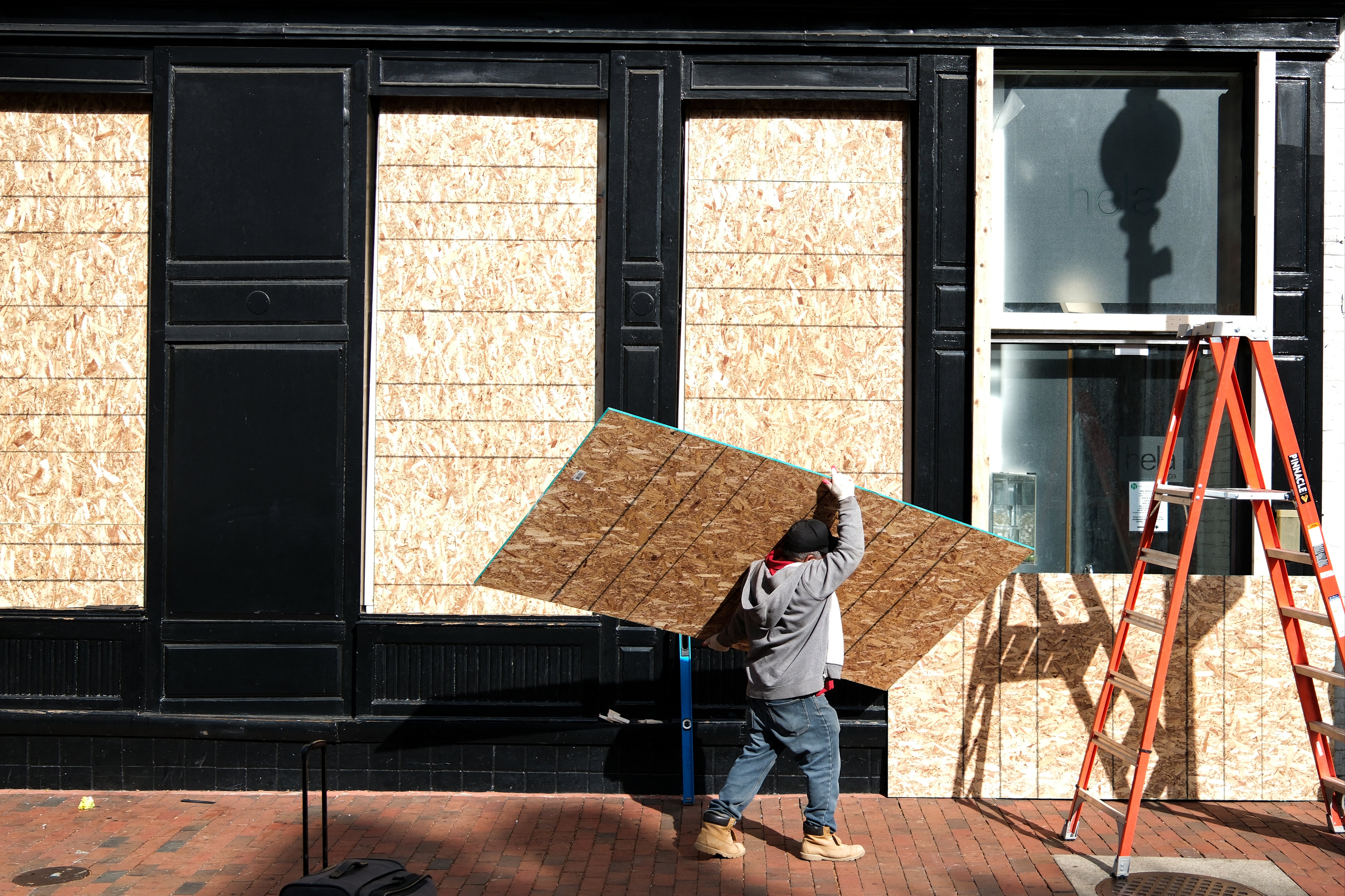 Workers board up a building in downtown DC on Election Day