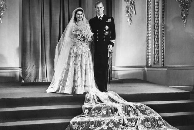 Princess Elizabeth and Lt Philip Mountbatten at Buckingham Palace after their wedding ceremony (PA)