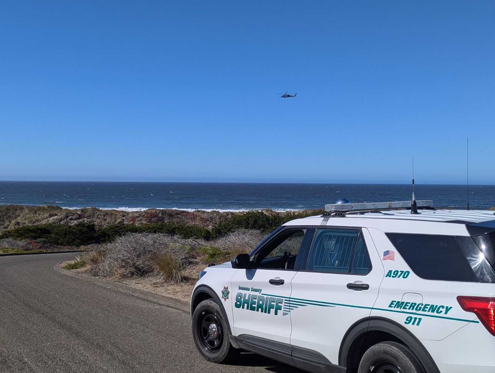 A Sonoma County Sheriff’s Office vehicle and a helicopter are seen by California’s Bodega Bay. Authorities continued to work this week after a second boat capsized in the area.