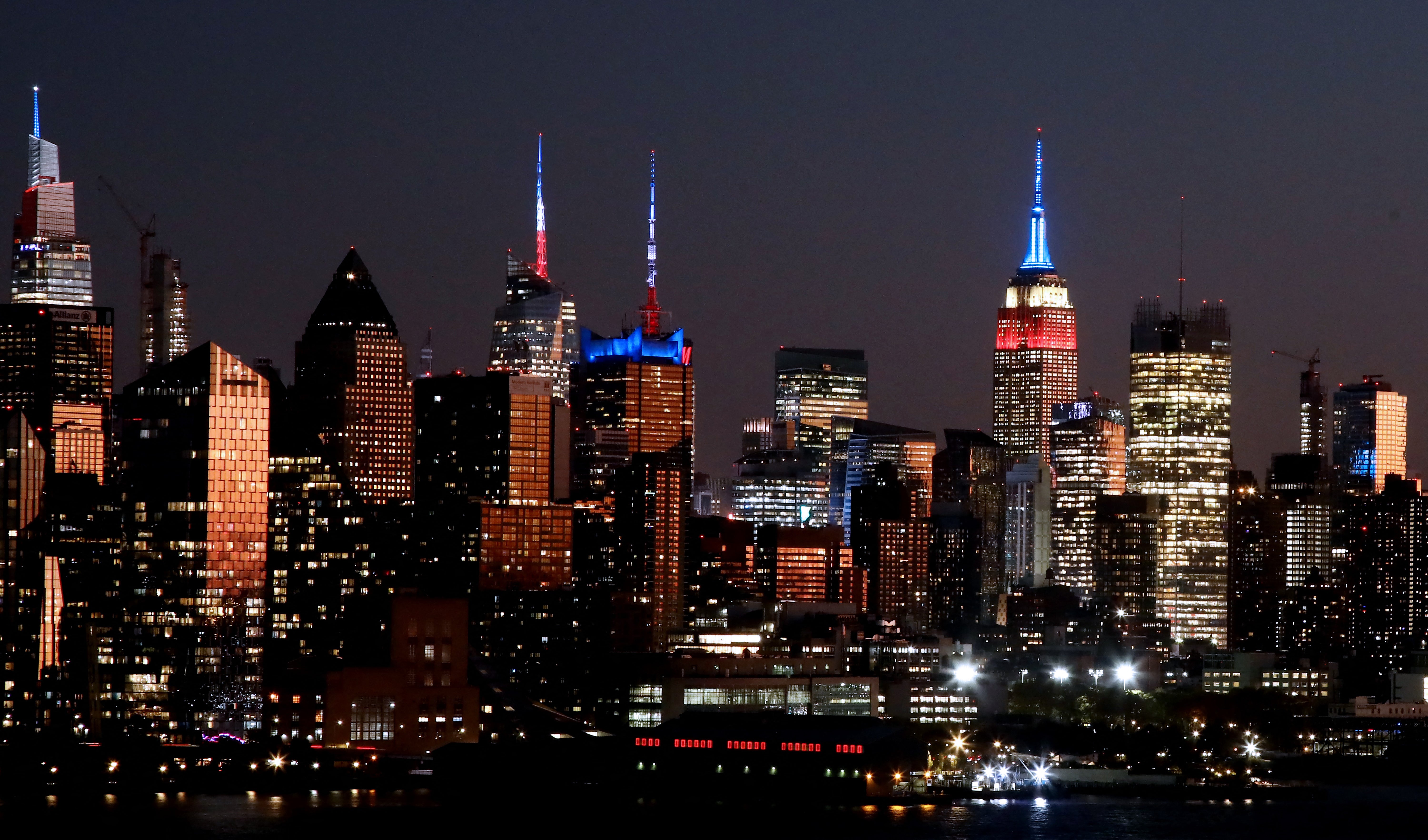 Buildings of the New York skyline, including the Empire State Building (C R), and viewed from West New York, New Jersey, are illuminated in red, white and blue to mark Election Day, November 5