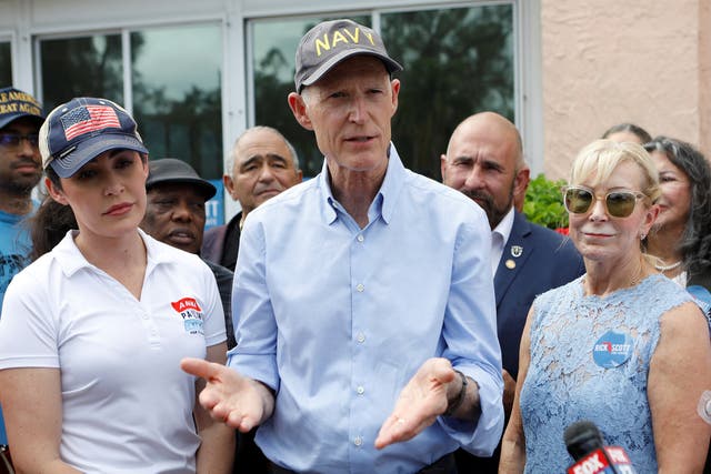 <p>Rick Scott, with congressional candidate Anna Paulina Luna, left, campaigning in Tampa on Election Day. Both held on to their seats </p>