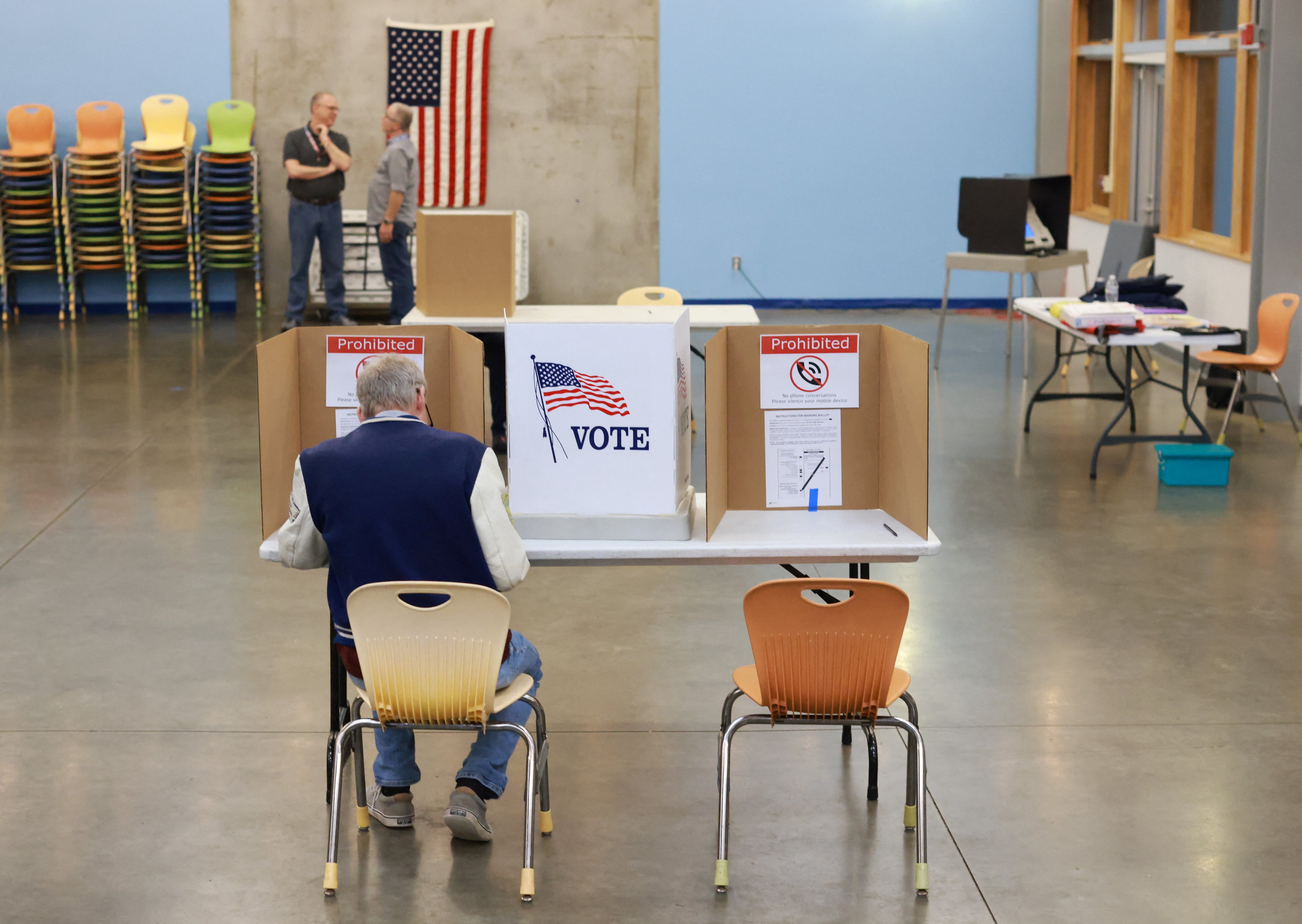 The last voter at a polling station casts their vote in Kalamazzoo, Michigan