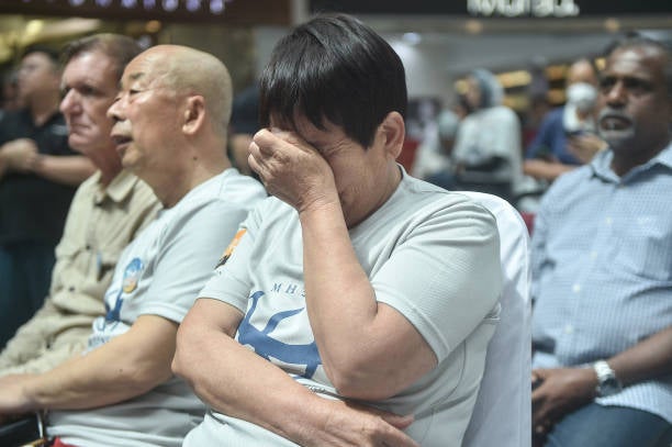  A comparative  reacts during an lawsuit   held by relatives of the passengers and supporters to people    the 10th twelvemonth  since the Malaysia Airlines formation  MH370 carrying 239 radical   disappeared