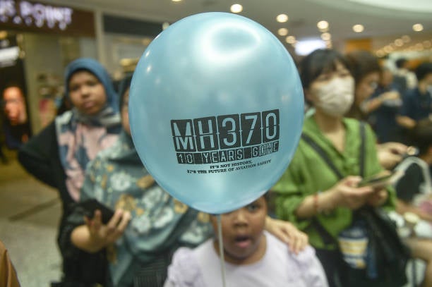 A idiosyncratic   holds a balloon during an lawsuit   held by relatives of the passengers and supporters to people    the 10th twelvemonth  since the Malaysia Airlines formation  MH370 carrying 239 radical   disappeared