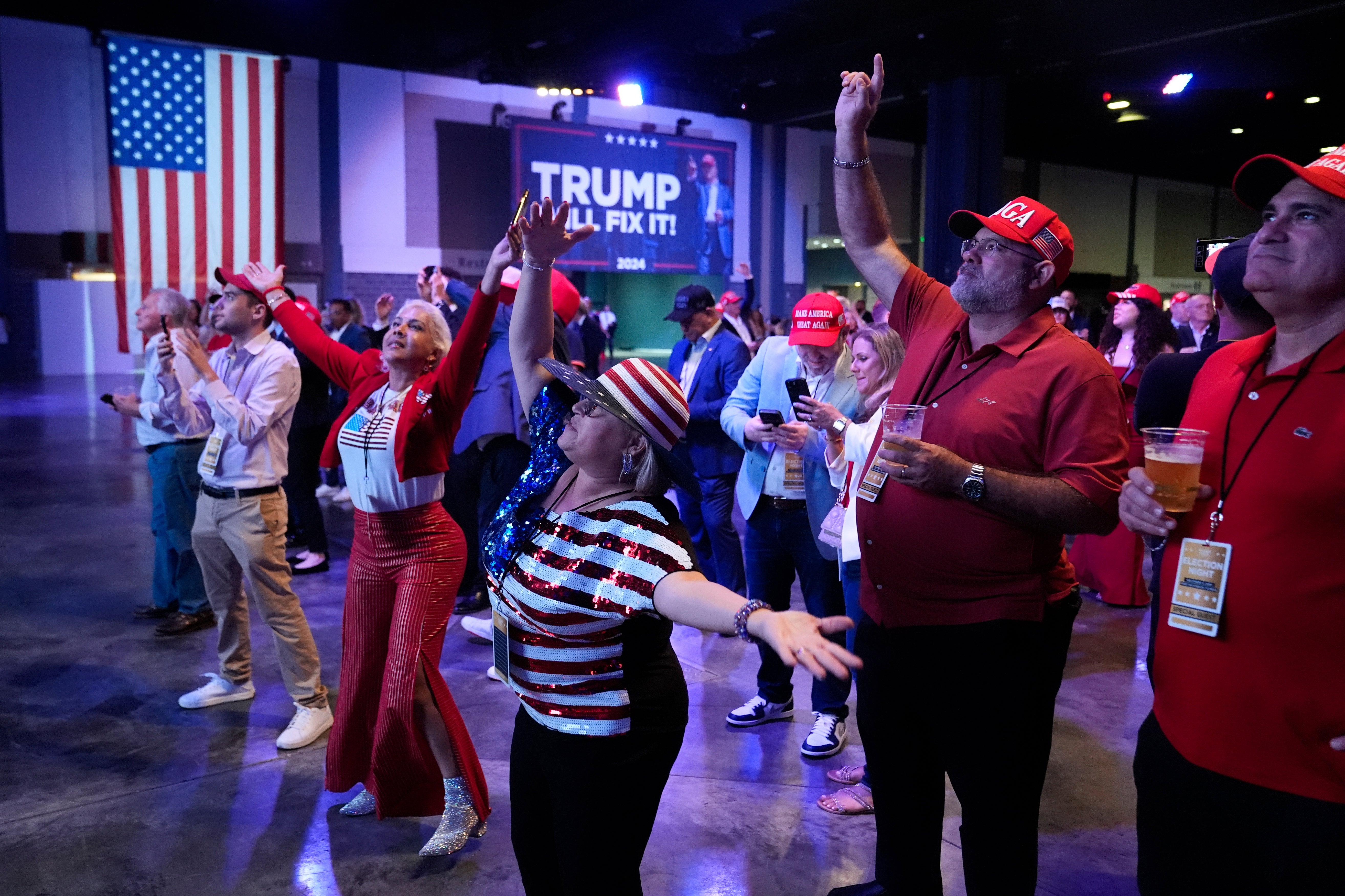 Supporters dance at an election night campaign watch party for Donald Trump in West Palm Beach, Florida