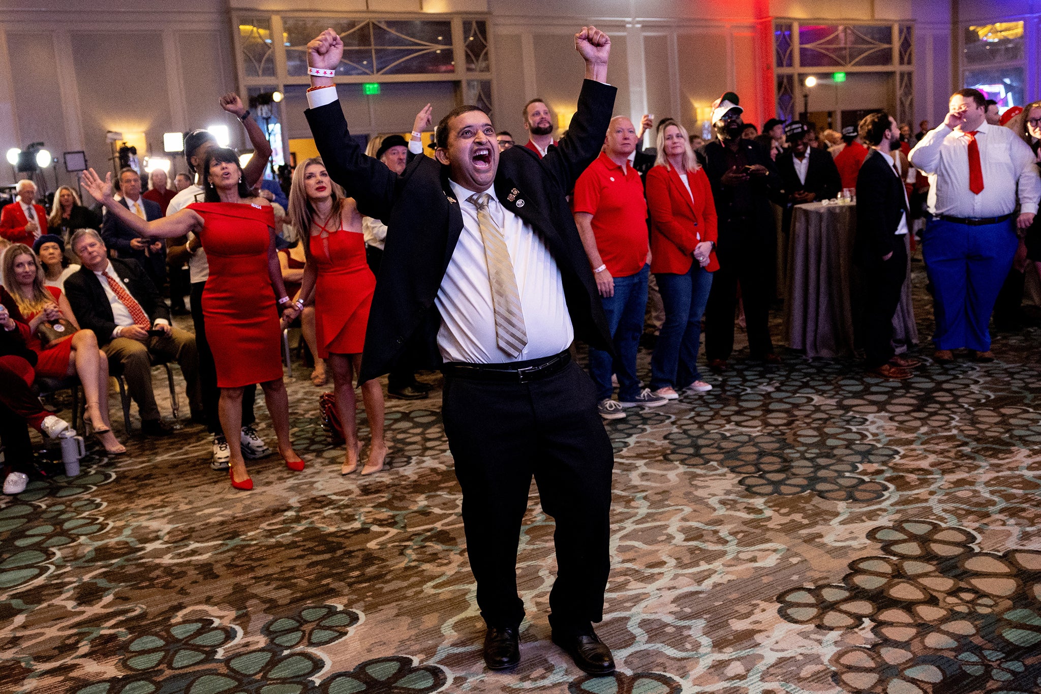 Supporters of Republican presidential nominee and former U.S. President Donald Trump react as they watch early election results