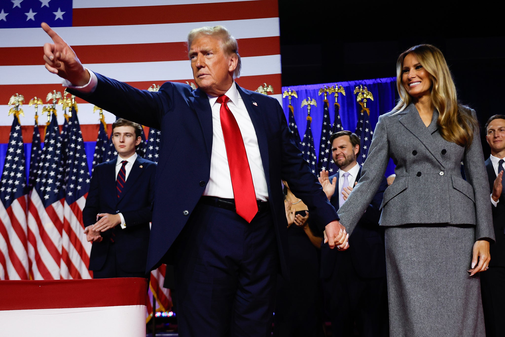 Republican presidential nominee, former U.S. President Donald Trump points to supporters with former first lady Melania Trump during an election night event at the Palm Beach Convention Center on November 06, 2024 in West Palm Beach, Florida