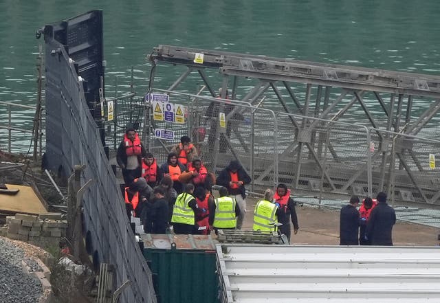 <p>A group of people thought to be migrants are brought in to Dover, Kent, from a Border Force vessel following a small boat incident in the Channel (Gareth Fuller/PA)</p>