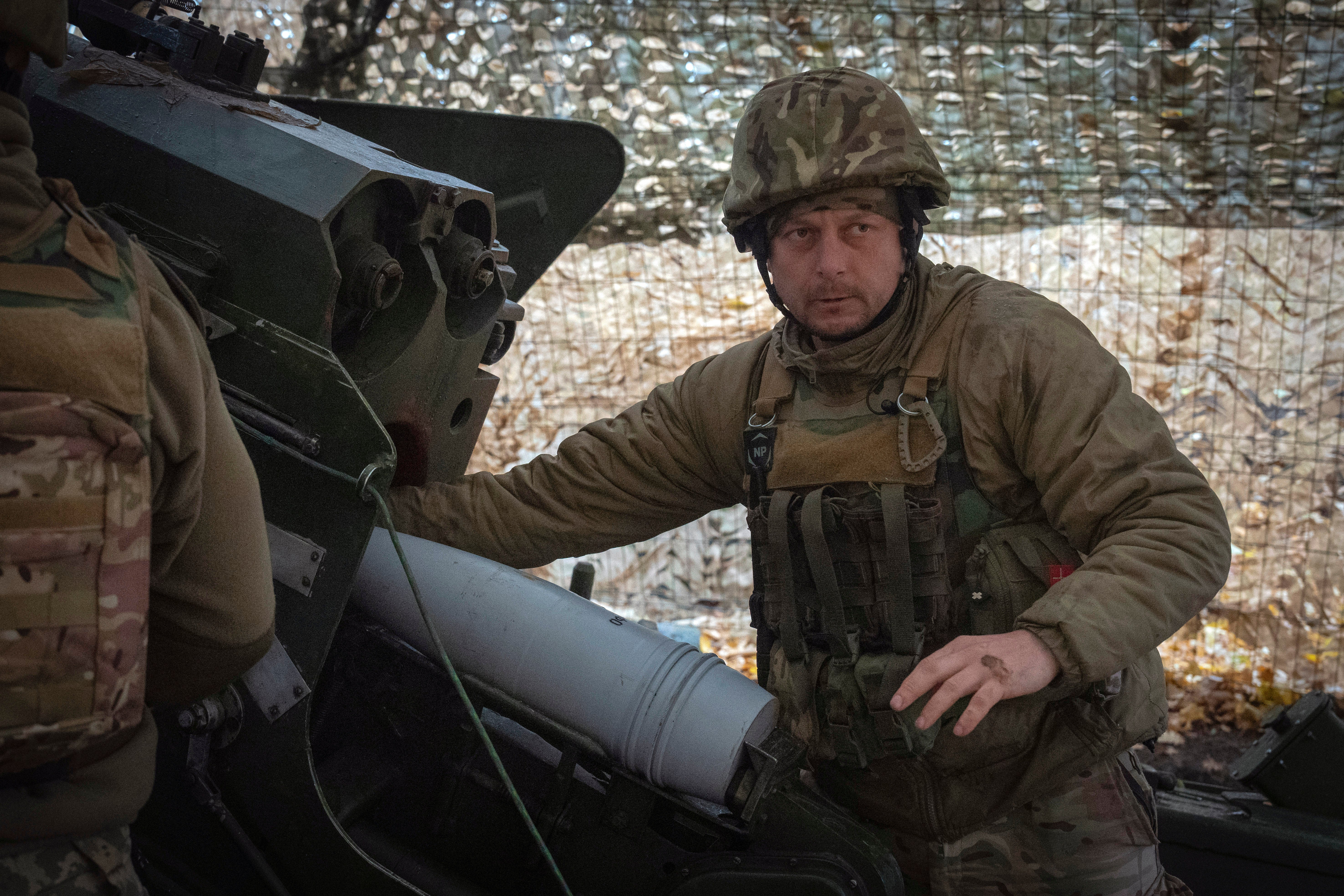 A serviceman of the 13th Brigade of the National Guard of Ukraine prepares to fire a Giatsint-B gun towards Russian position