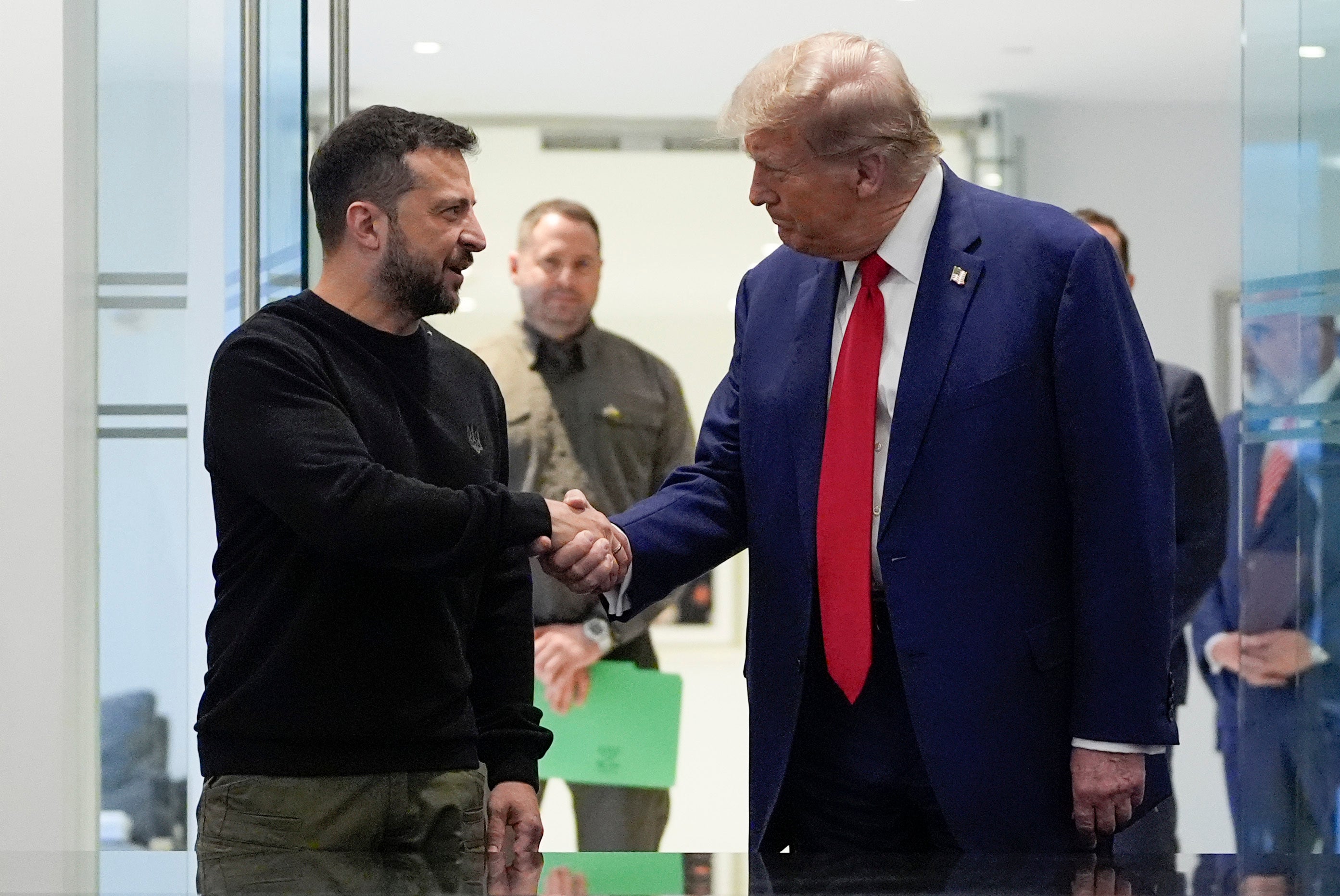 President Donald Trump and Ukraine's President Volodymyr Zelensky shake hands during a meeting at Trump Tower