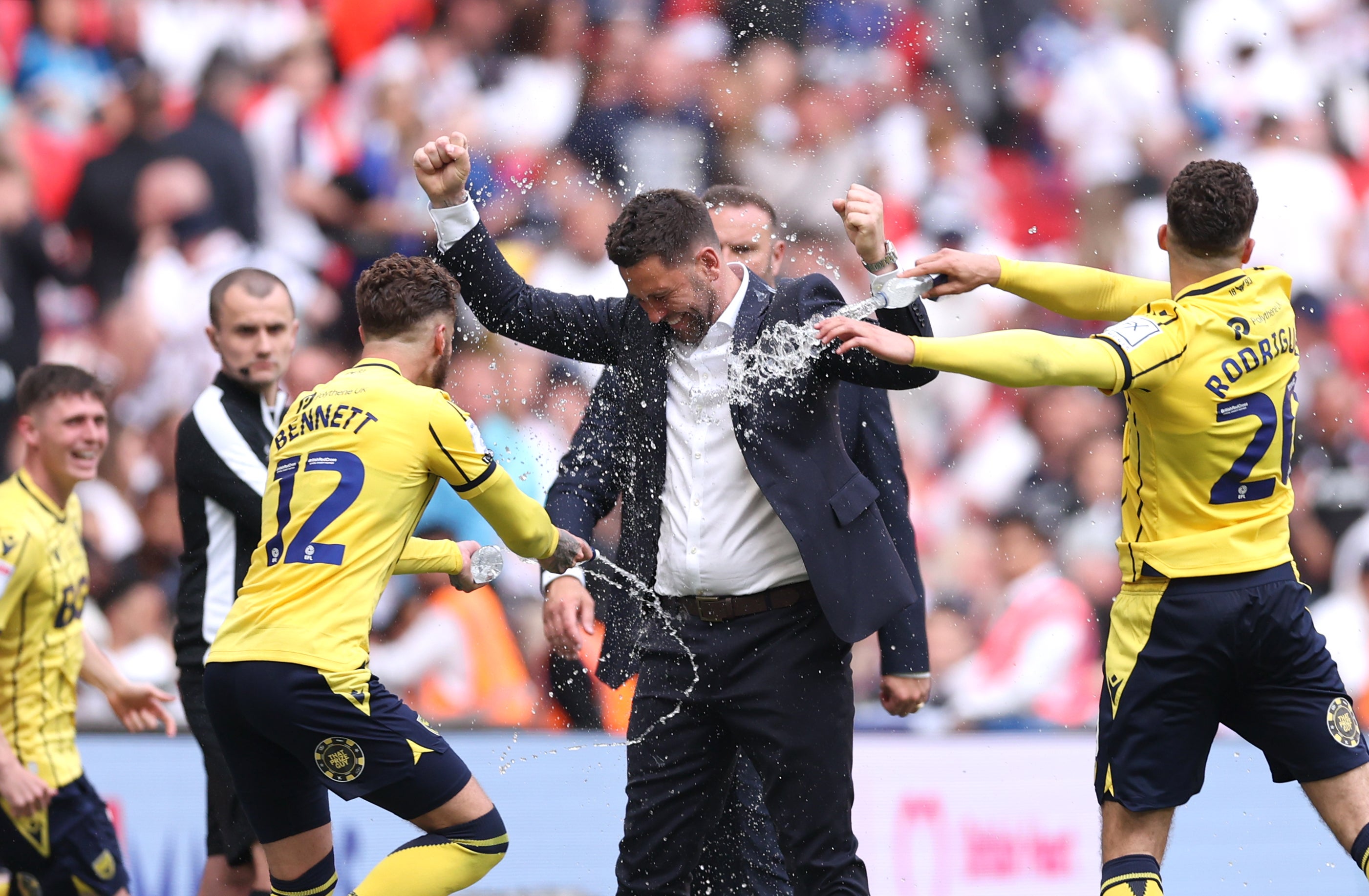 Oxford players soak the manager at full time after the League One play-off final