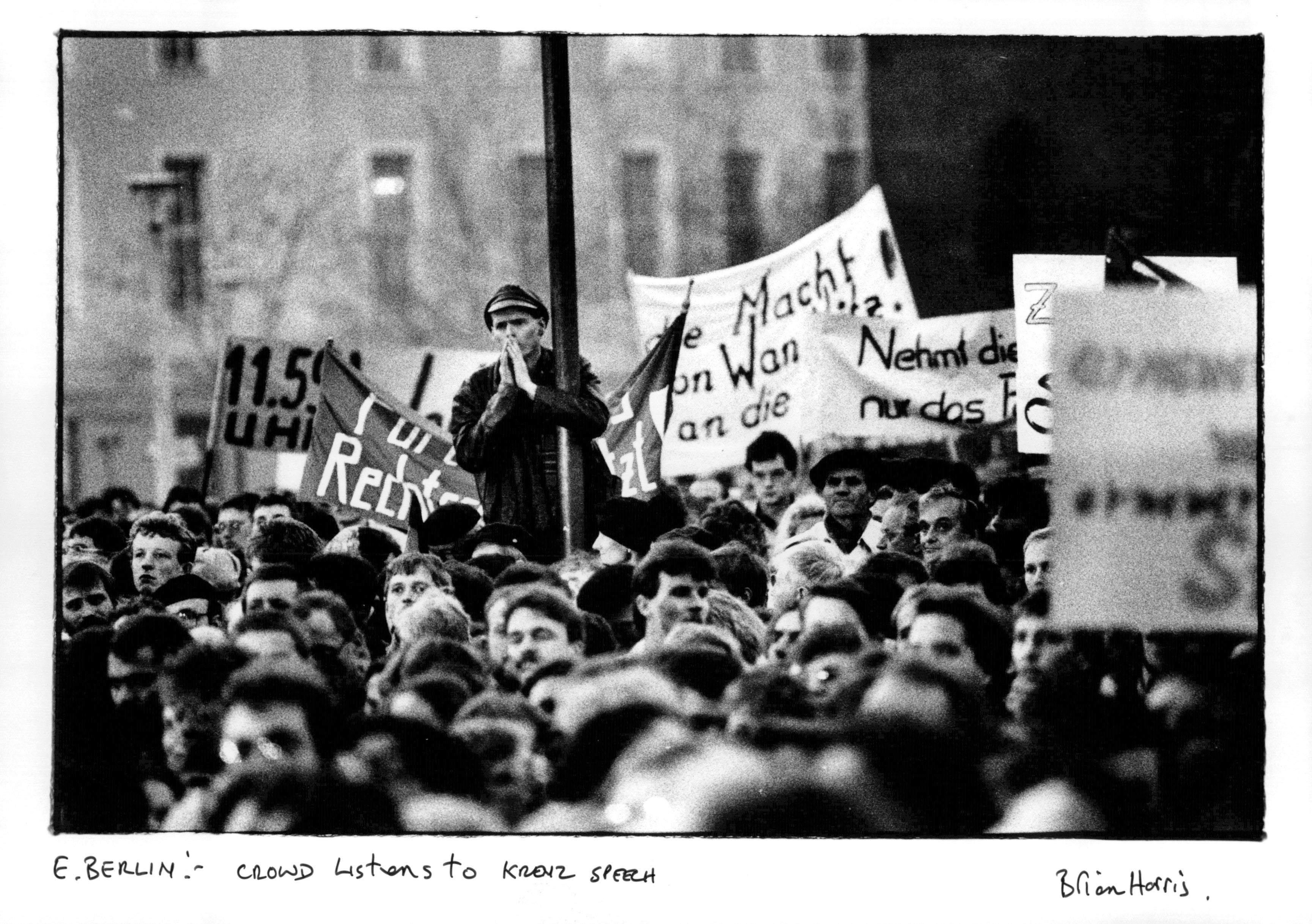 Protesters gather in East Berlin, listening to a speech by Egon Krenz