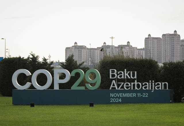 <p>A view shows a sign of the Cop29 United Nations Climate Change Conference with a backdrop of the cityscape in Baku, Azerbaijan</p>