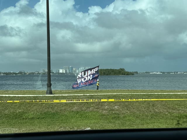 <p>A supporter of Donald Trump holds a large flag that reads “Trump Won” near the president-elect’s Mar-a-Lago club in Palm Beach on November 6, 2024</p>