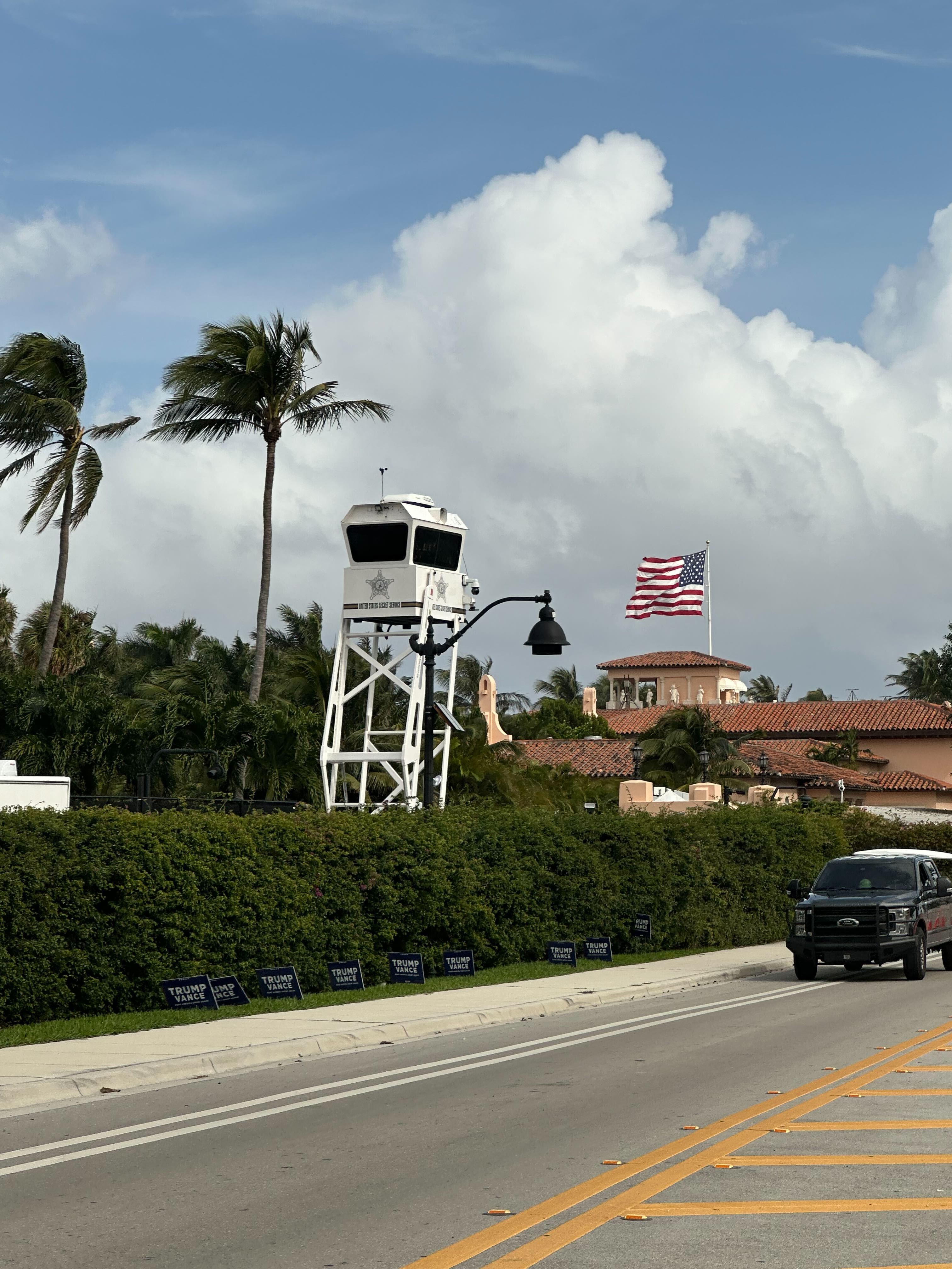 A Secret Service watchtower and a large American flag ar visible above the roofline of President-elect Donald Trump’s Mar-a-Lago property on November 6, 2024