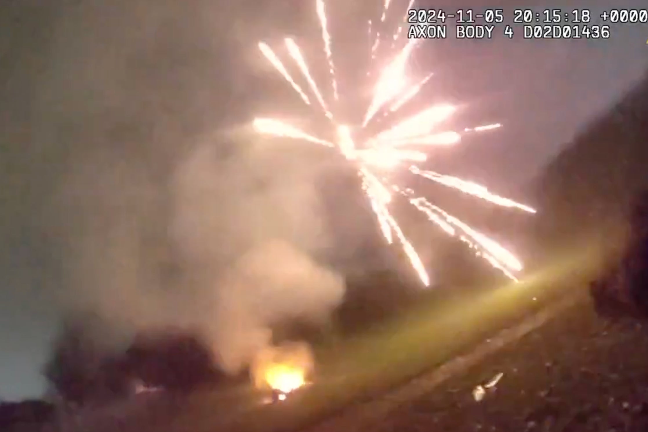 A firework explodes near officers