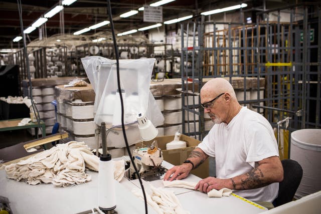 <p>James Dickert, sews socks together in a prison factory at California Men’s Colony prison on December 19, 2013 in San Luis Obispo, California</p>