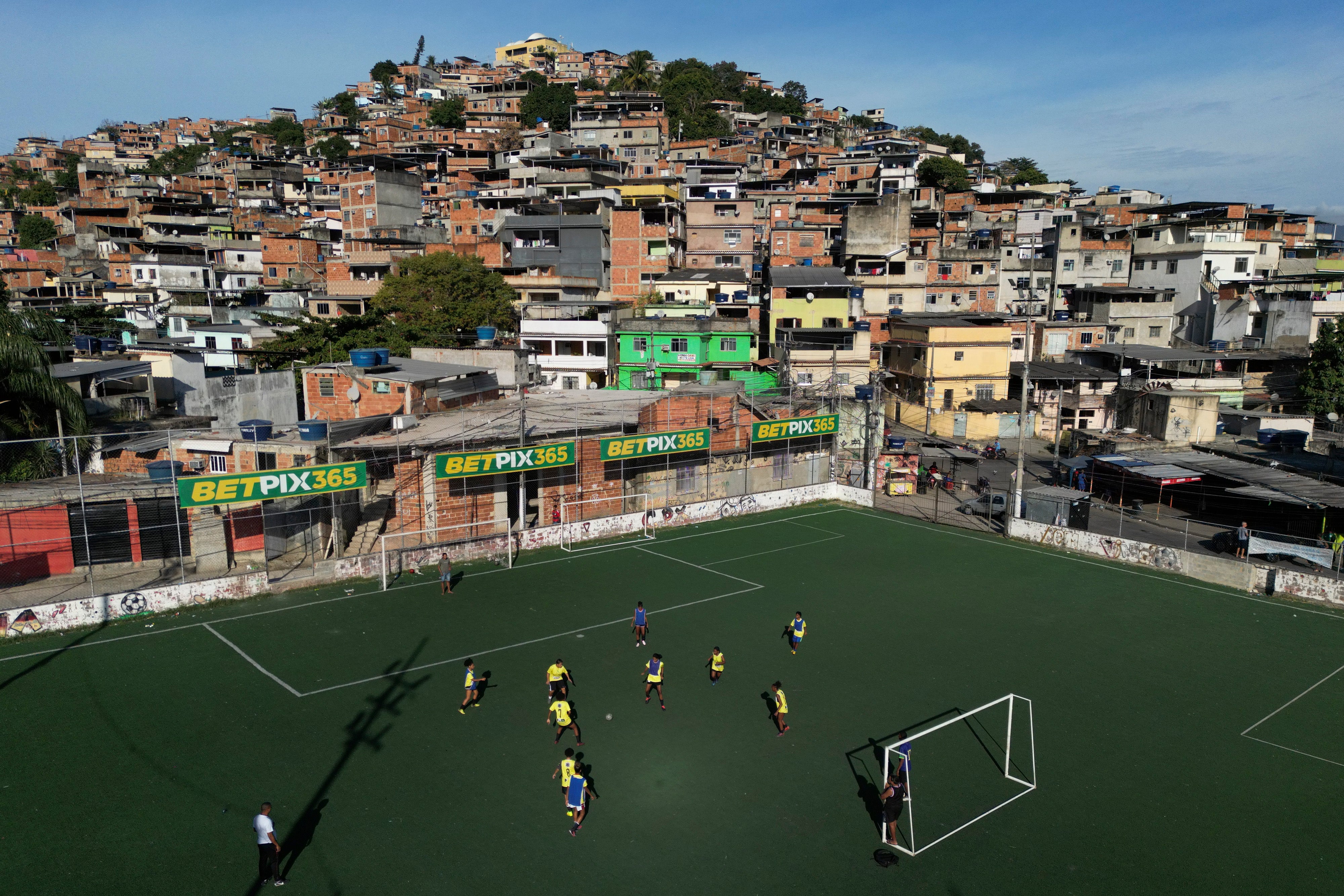 Betting company advertisements adorn a soccer field during a training program run by non-governmental organization "Cara a Cara" in the Complexo do Alemao favela, in Rio de Janeiro, Brazil