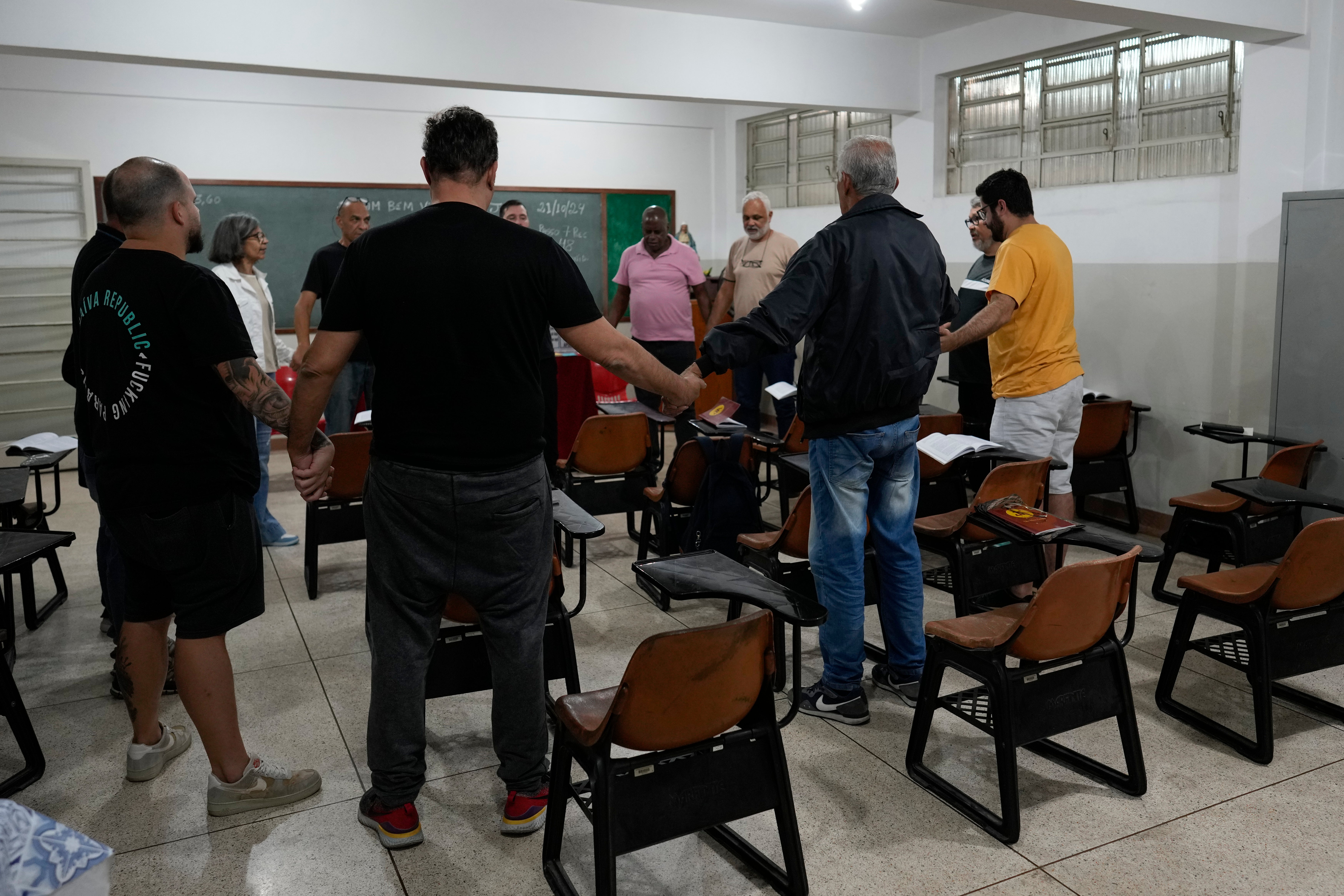 Gamblers in recovery pray during a Gamblers Anonymous meeting in Sao Paulo