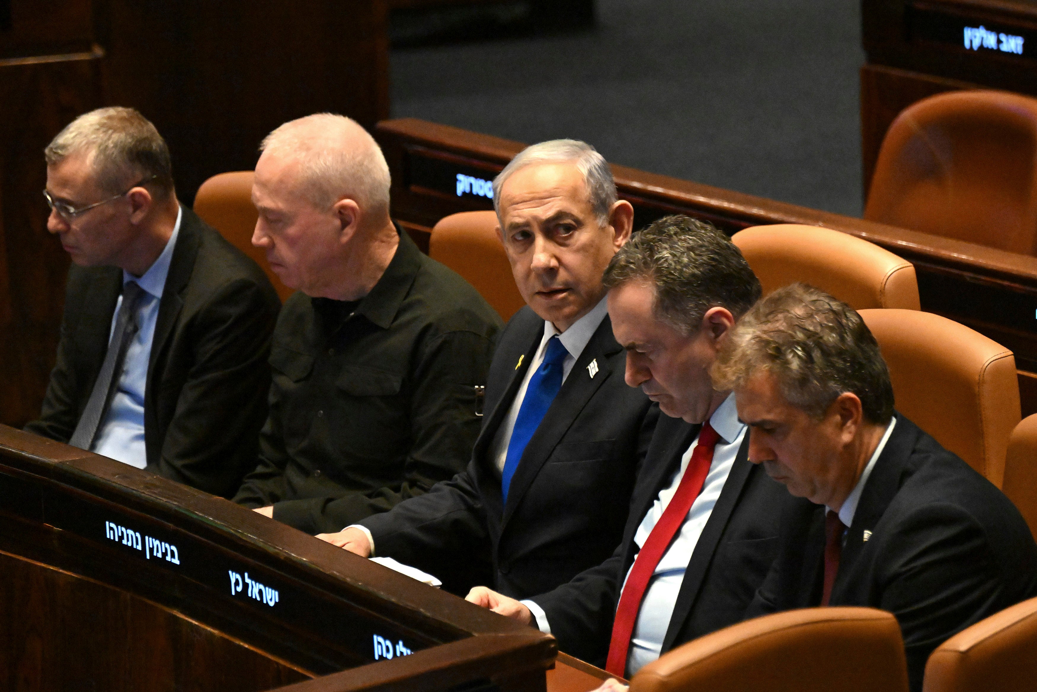 Israeli Prime Minister Benjamin Netanyahu, center, flanked by Defense Minister Yoav Gallant, second from left, attends at the opening of the 25th Knesset session marking the anniversary of the "Iron Swords" war, in Jerusalem, Monday, Oct. 28, 2024