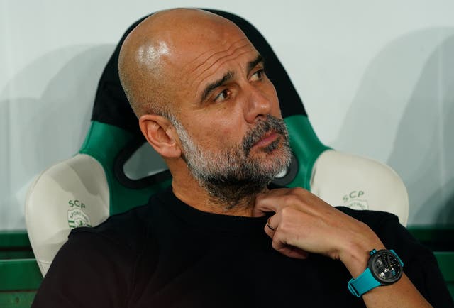 <p>Pep Guardiola looks on during the Champions League match between Sporting and Man City</p>