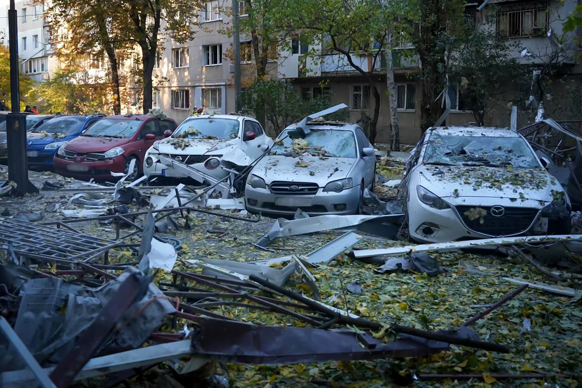 Damaged cars are seen in the courtyard of a residential building following a drone attack in Odesa, southern Ukraine