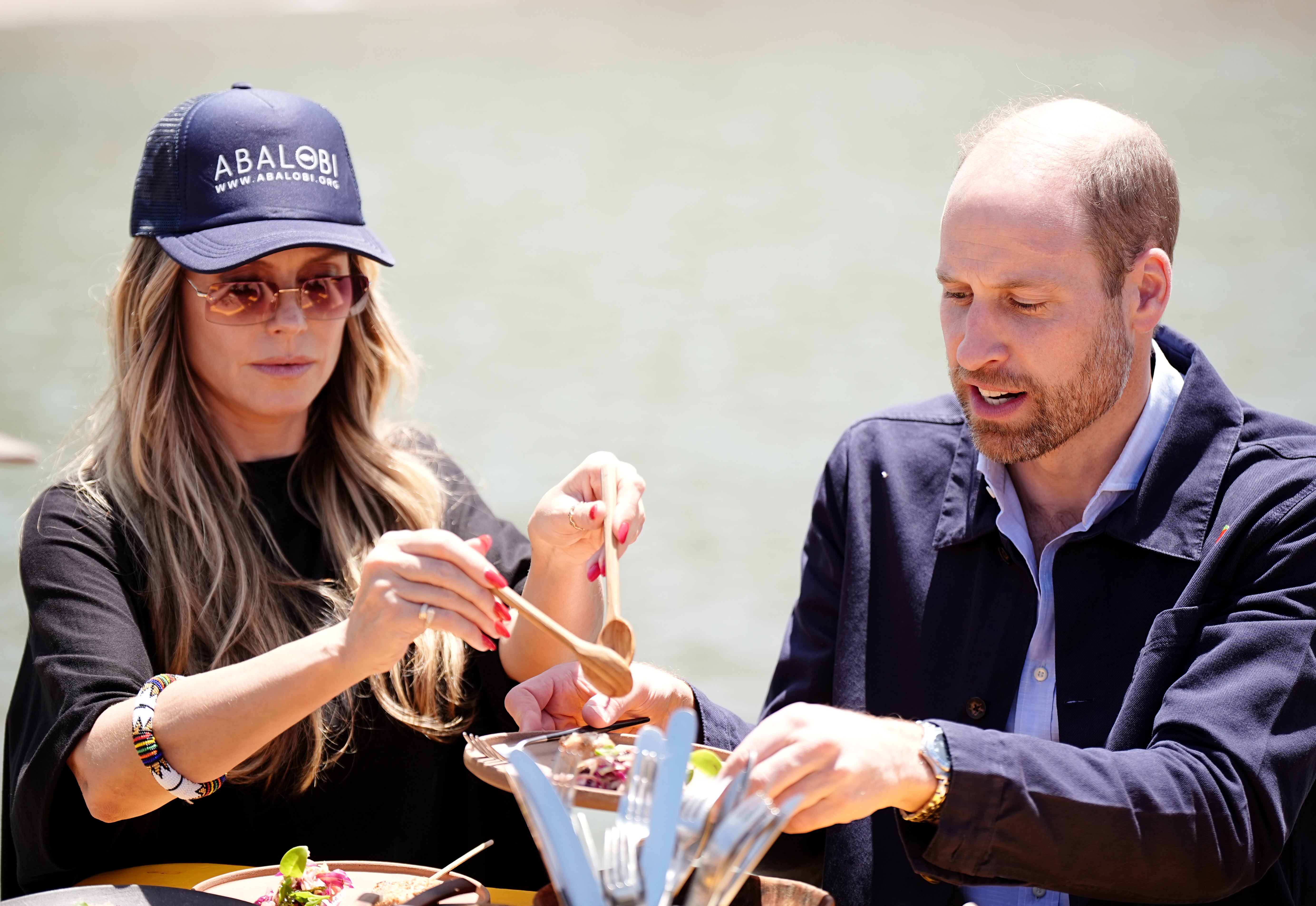 The Prince of Wales with Heidi Klum, during his visit to meet local fishermen in Kalk Bay Harbour, Cape Town