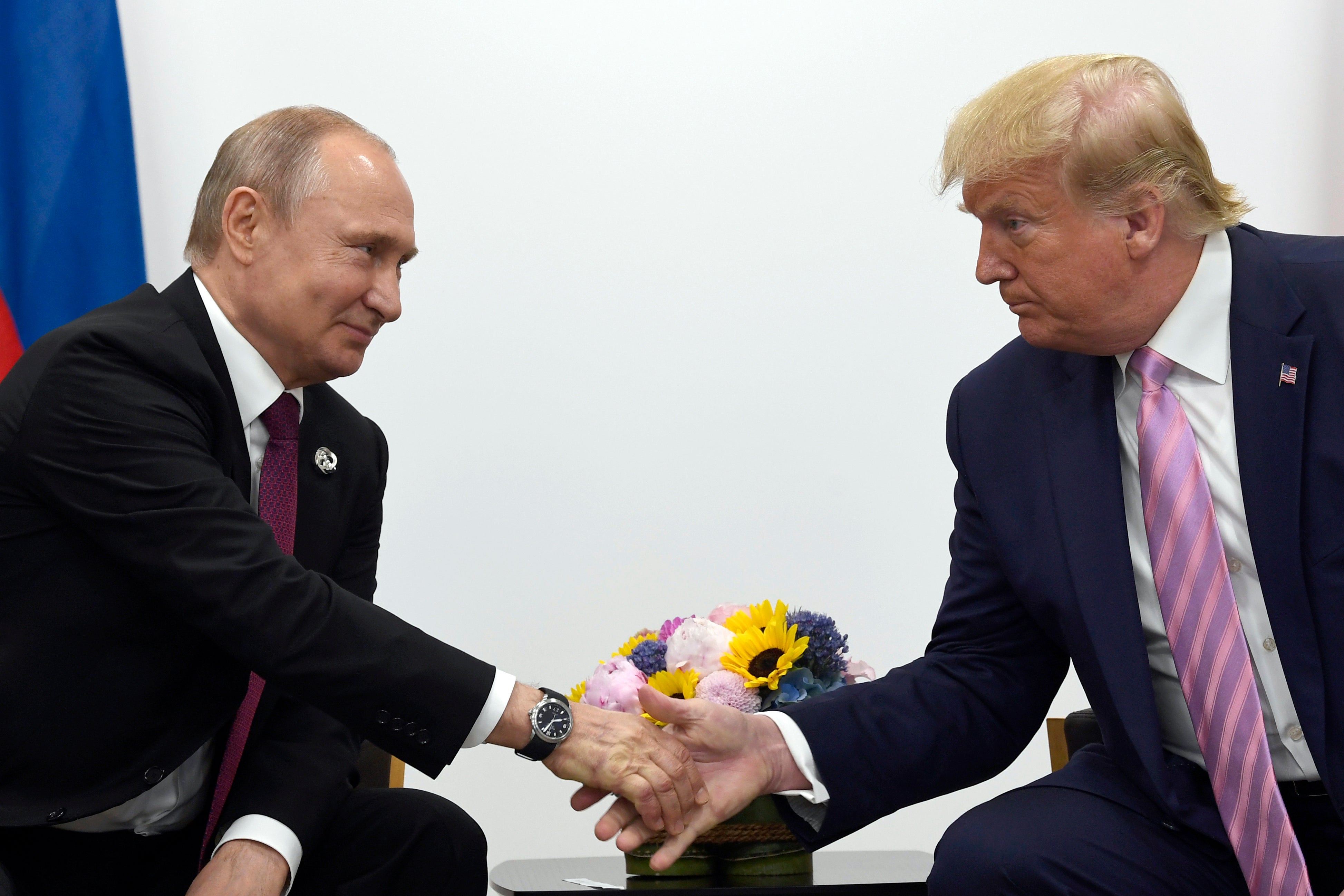 In this June 28, 2019, file photo, President Donald Trump shakes hands with Russian President Vladimir Putin during a bilateral meeting on the sidelines of the G-20 summit in Osaka, Japan