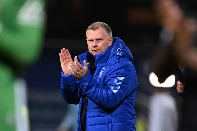 <p>Coventry manager Mark Robins applauds the fans at Loftus Road</p>