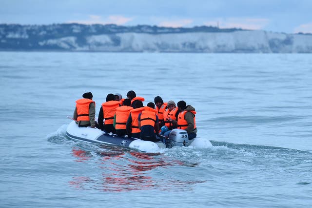 <p>File photo of people in a dinghy crossing the Channel. </p>